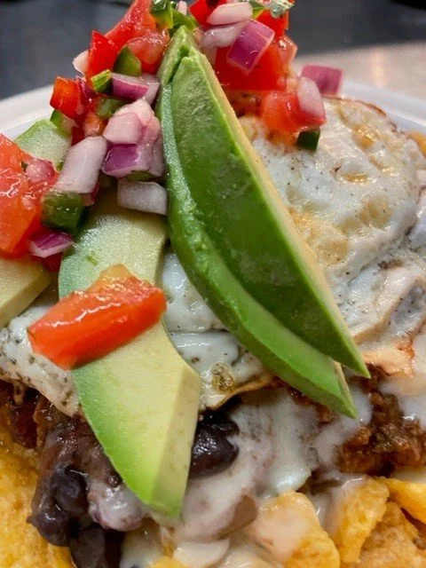 Brunch breakfast item. Seasonal Frito pie with house made bison, brisket chili. Avocado, pico, and egg.