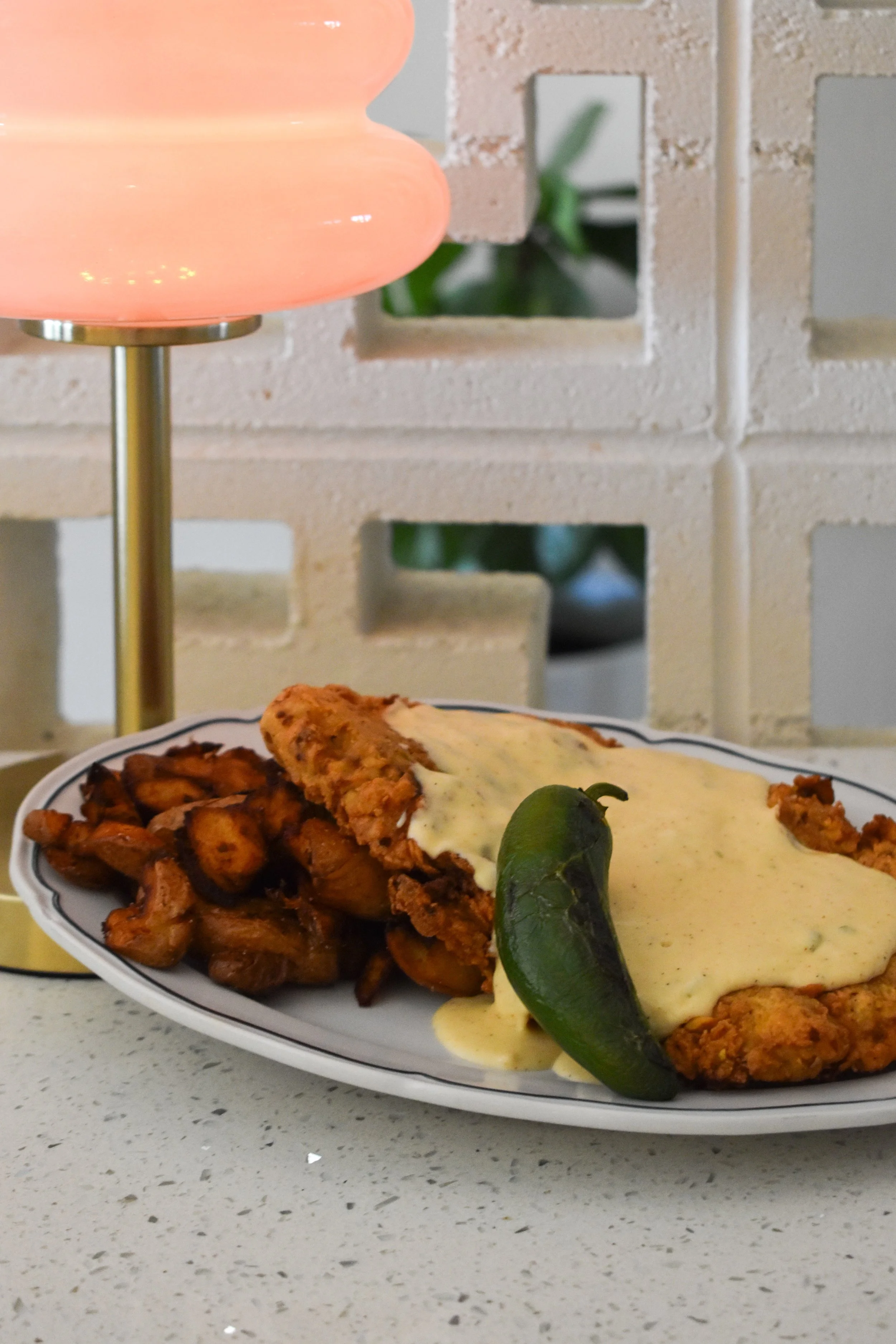 Awarded one of the best chicken fried steaks in bryan college station/ brazos valley. hand battered Pistachio crushed chicken fried beef cutlet. House made jalapeno gravy. Vegatarian friendly gravy. Grilled jalapenos. Crushed potatoes.