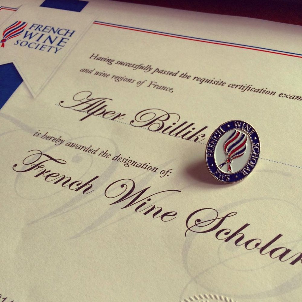 Certificate from the French Wine Society with a pin, awarding the designation of French Wine Scholar.