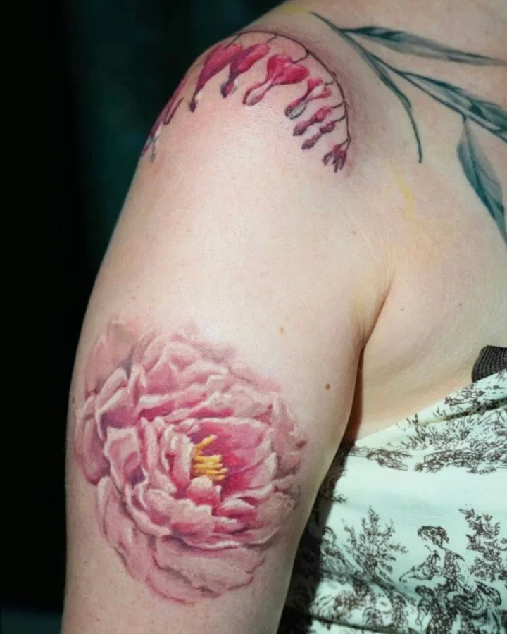 Every flower in this tattoo represents a real person or place in Kirsten&rsquo;s life.🌿

She wanted an assortment that could grow over time. We started with bleeding hearts and a peony, then added poppies in the second session. The faint purple line