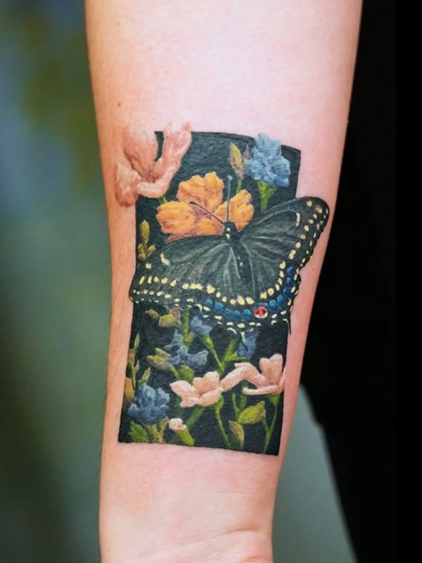 She came in saying she was embracing her dark phase.🖤

The dark background wasn&rsquo;t just an aesthetic choice. It&rsquo;s what makes every color in this piece come alive.

A butterfly resting among yellow, blue, and white wildflowers. Each plant 