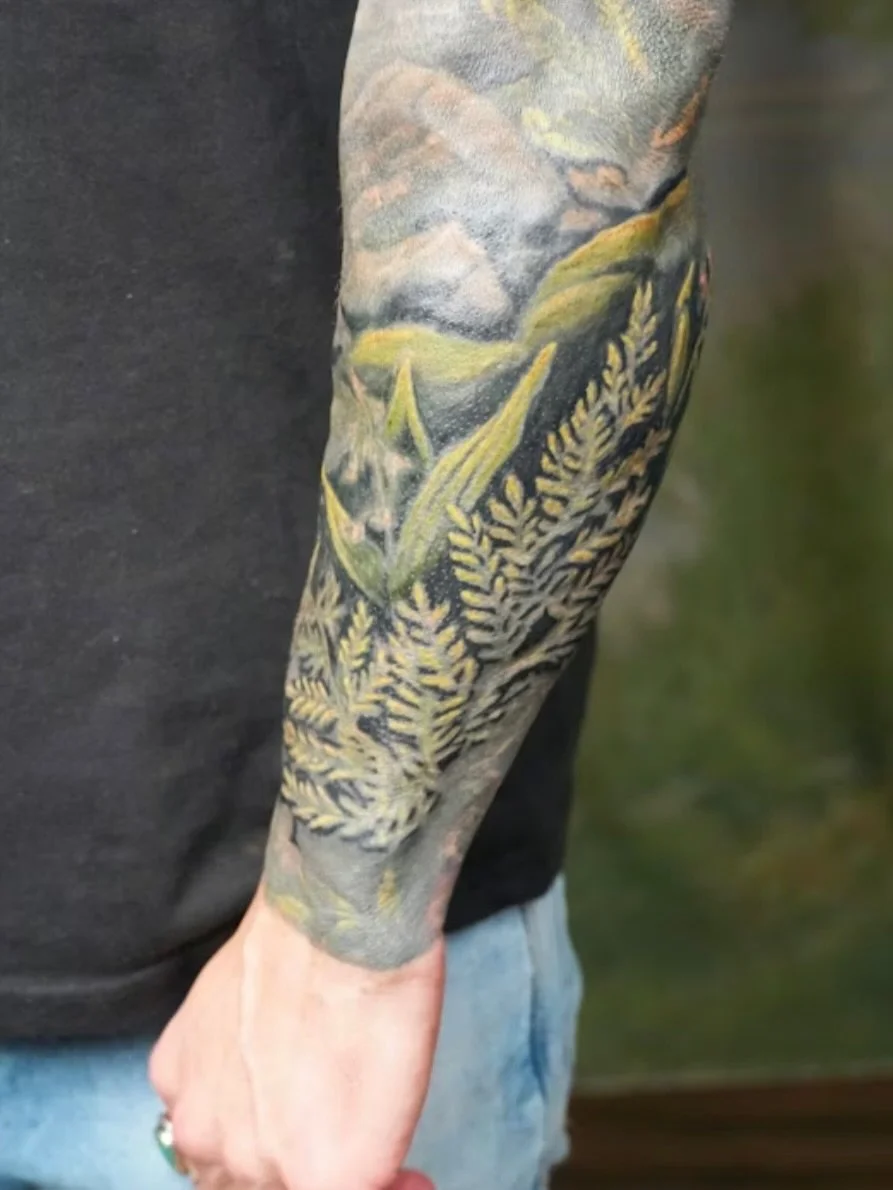 His entire arm was solid black when we started...😳

Every fern, every leaf, every detail you see here was carved out of that. No blank skin to work with, just pure black and the challenge of pulling something from it.

I don&rsquo;t usually do cover