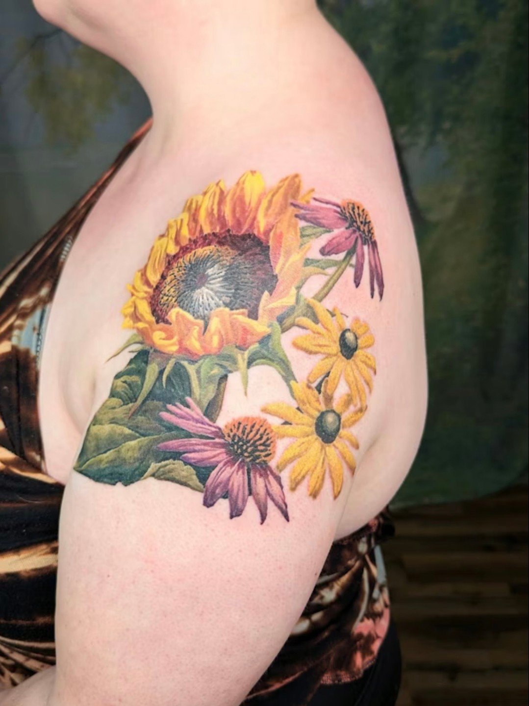 Welcome back! Here is where we landed.

Stacey&rsquo;s shoulder cap is finished. Flowers she and her mom grew up with, a large sunflower leaf anchoring the bottom, and all the negative space she envisioned letting each bloom breathe.

Her mom&rsquo;s