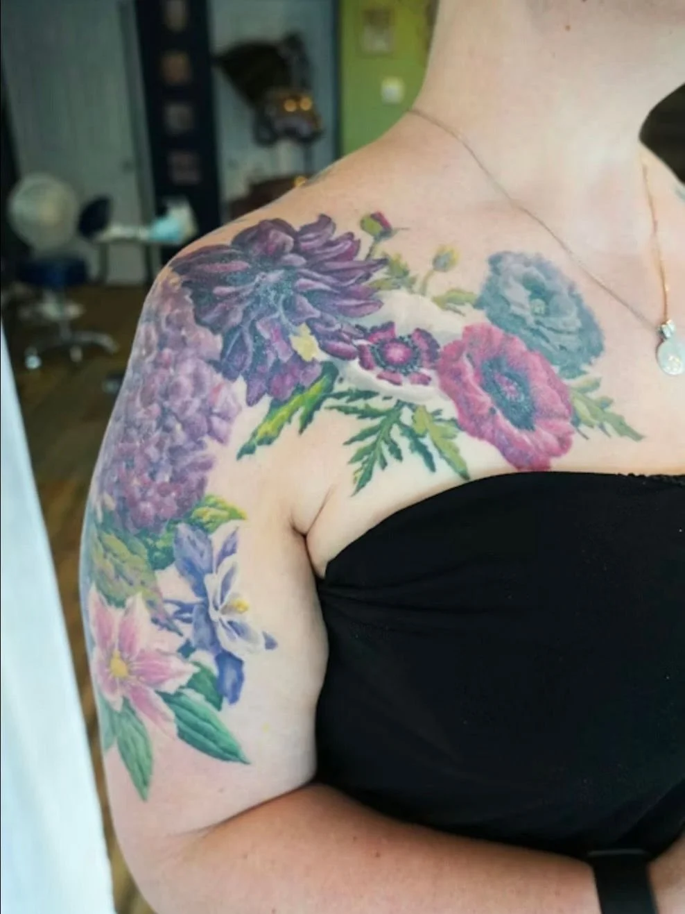 Can you believe this is 4 to 5 years healed?

Izzy wanted a design that transitions from life to death. Poppies and clematis up front, colorful but look closely and you will notice the leaves aging. The hydrangea goes from vibrant to dying. Dead stem