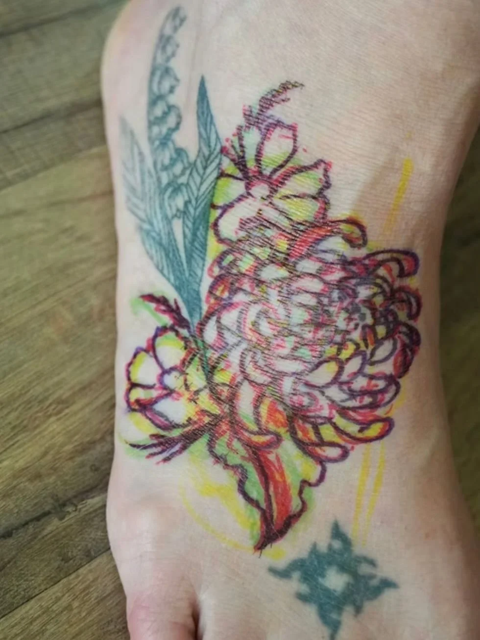 Ever wonder what happens before the needle even touches your skin?

Laura came to me with lily of the valley that had botanically inaccurate leaves and it was bothering her. We fixed the venation and colored them in correctly. Then we drew on a chrys