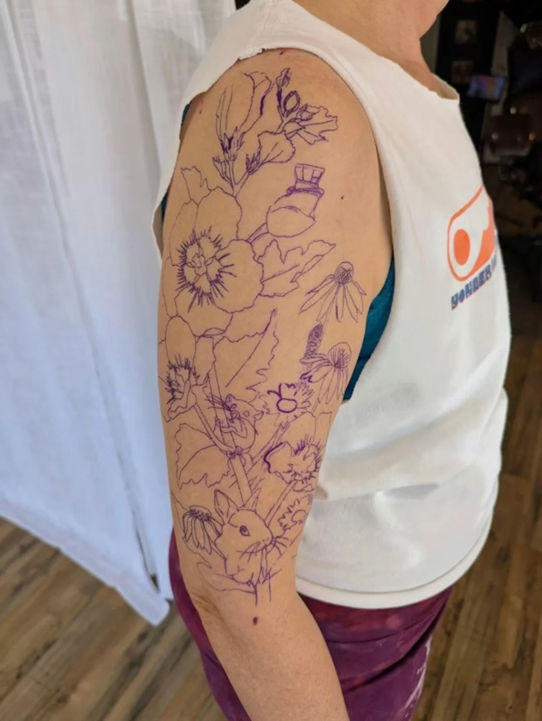 She is the dormouse. Her husband is the Mad Hatter. Their dear friend is the white rabbit. Personas the three of them decided on together in college and never let go of.🥹

George Ann wanted all of that woven into a tattoo alongside a rose of Sharon,
