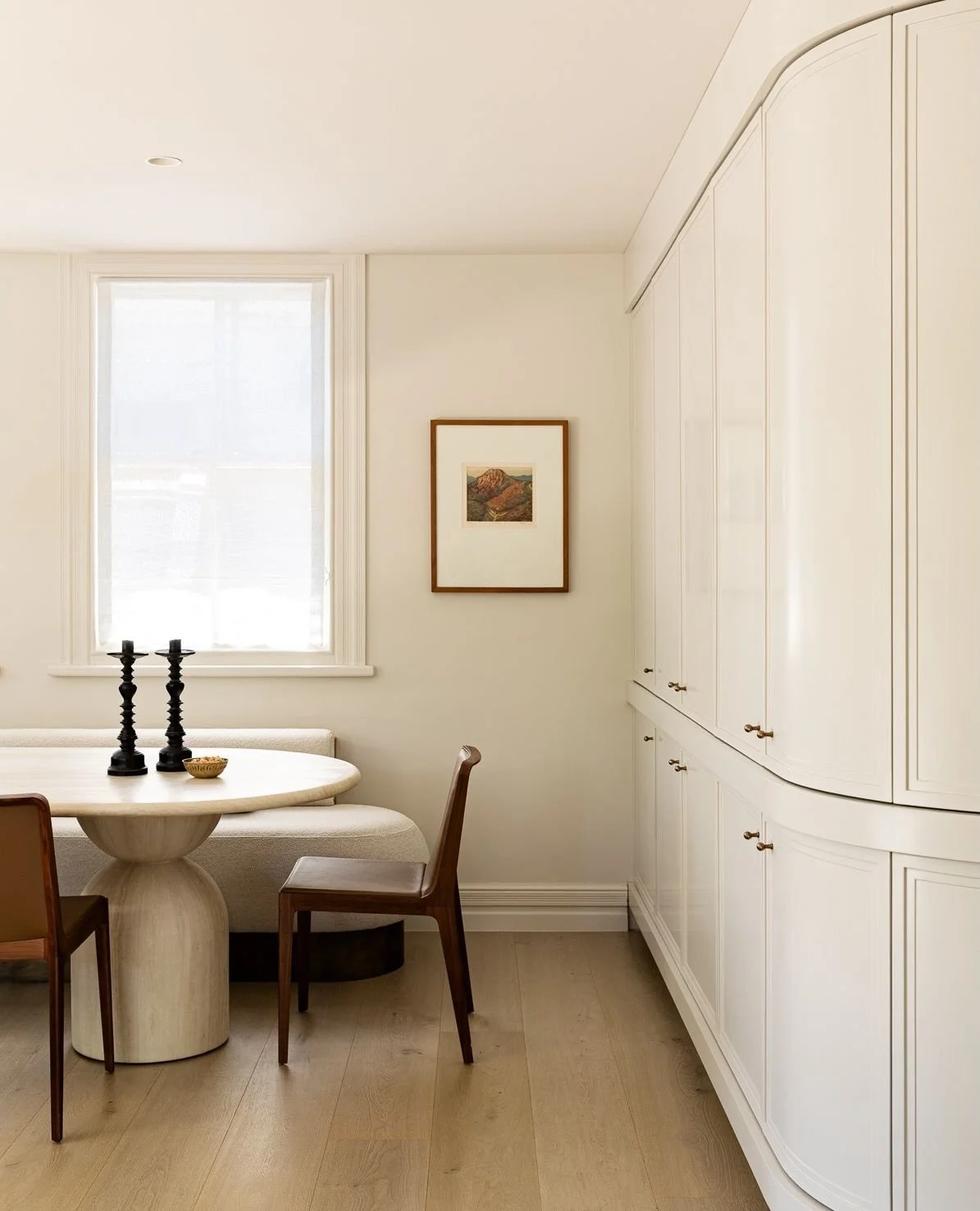 A calm kind of luxury.
The kind you feel more than you notice at first. 

Custom cabinetry fills one wall and wraps towards the room&rsquo;s entrance, with a hidden bar cupboard tucked at the end. It&rsquo;s marble-lined and softly lit, like a quiet 