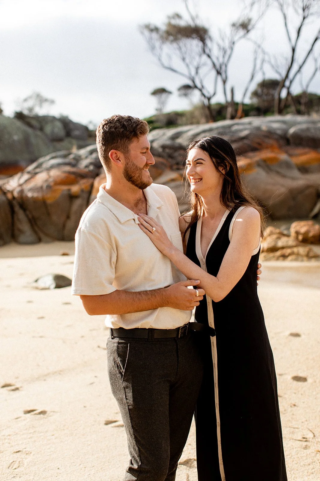 Man and woman after the man has proposed at the beach in Tasmania