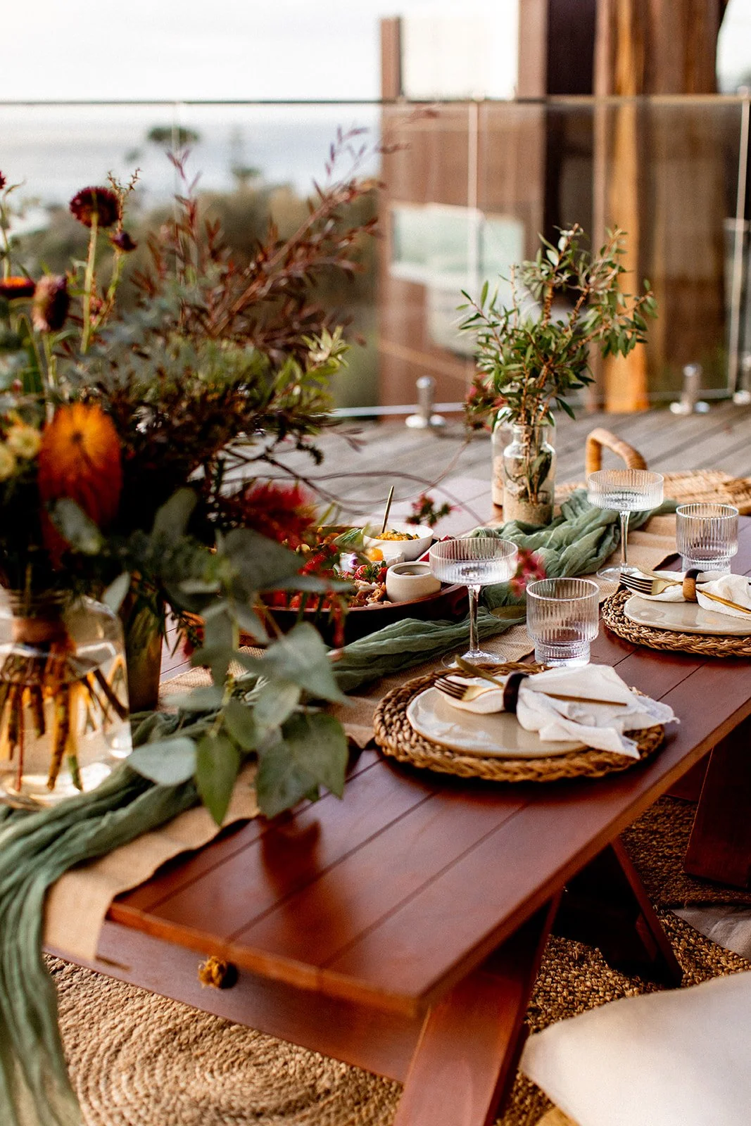 Native flowers on table with picnic set up at an airbnb in Binalong Bay.