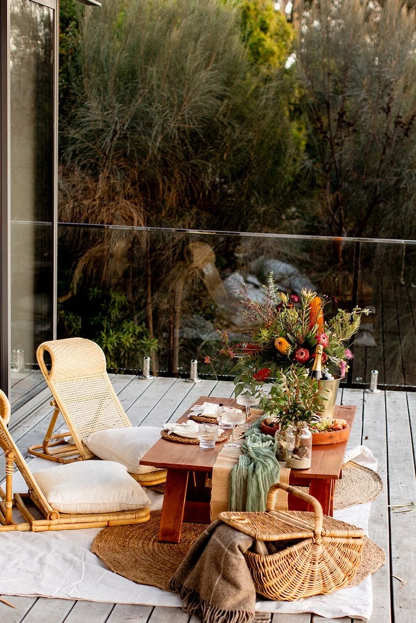 Picnic set up on a deck in Binalong Bay in Tasmania for a proposal.