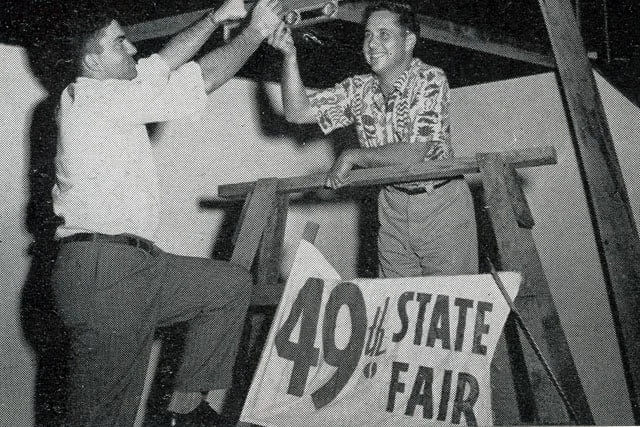 Frank May, left, and Alex Castro, chairman of Honolulu Junior Chamber of Commerce fair committee, setting up for what was then known as the 49th State Fair