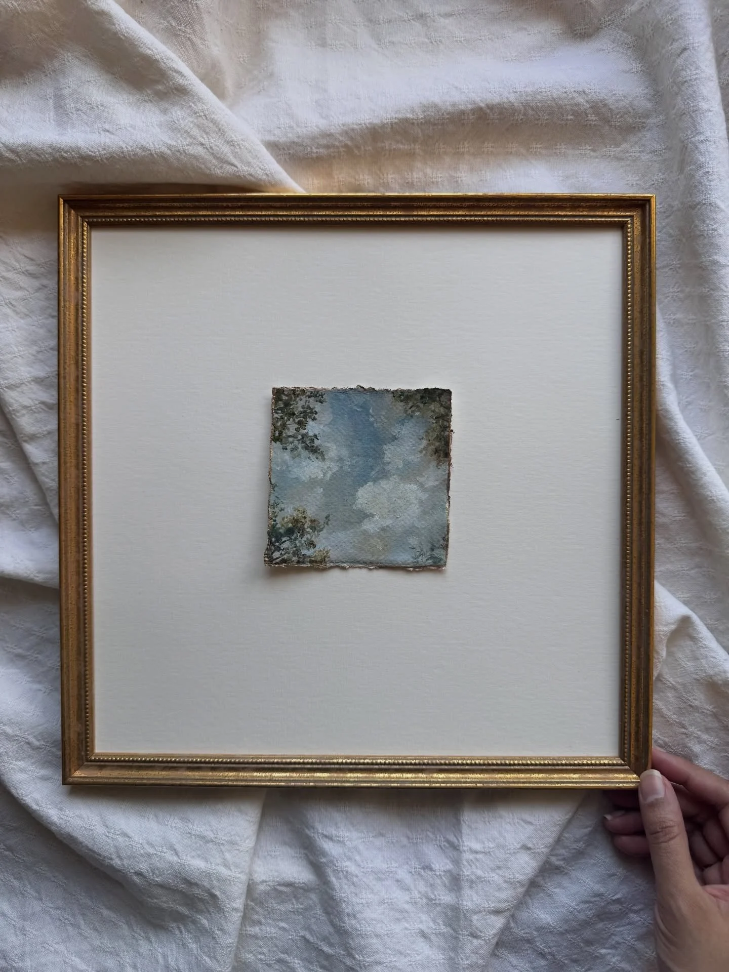 A smaller work from the looking up series.

The space around it is just as important as the painting itself.
It creates distance, like standing beneath something and taking it in slowly.

The torn edges are finished with gold to catch light as it mov