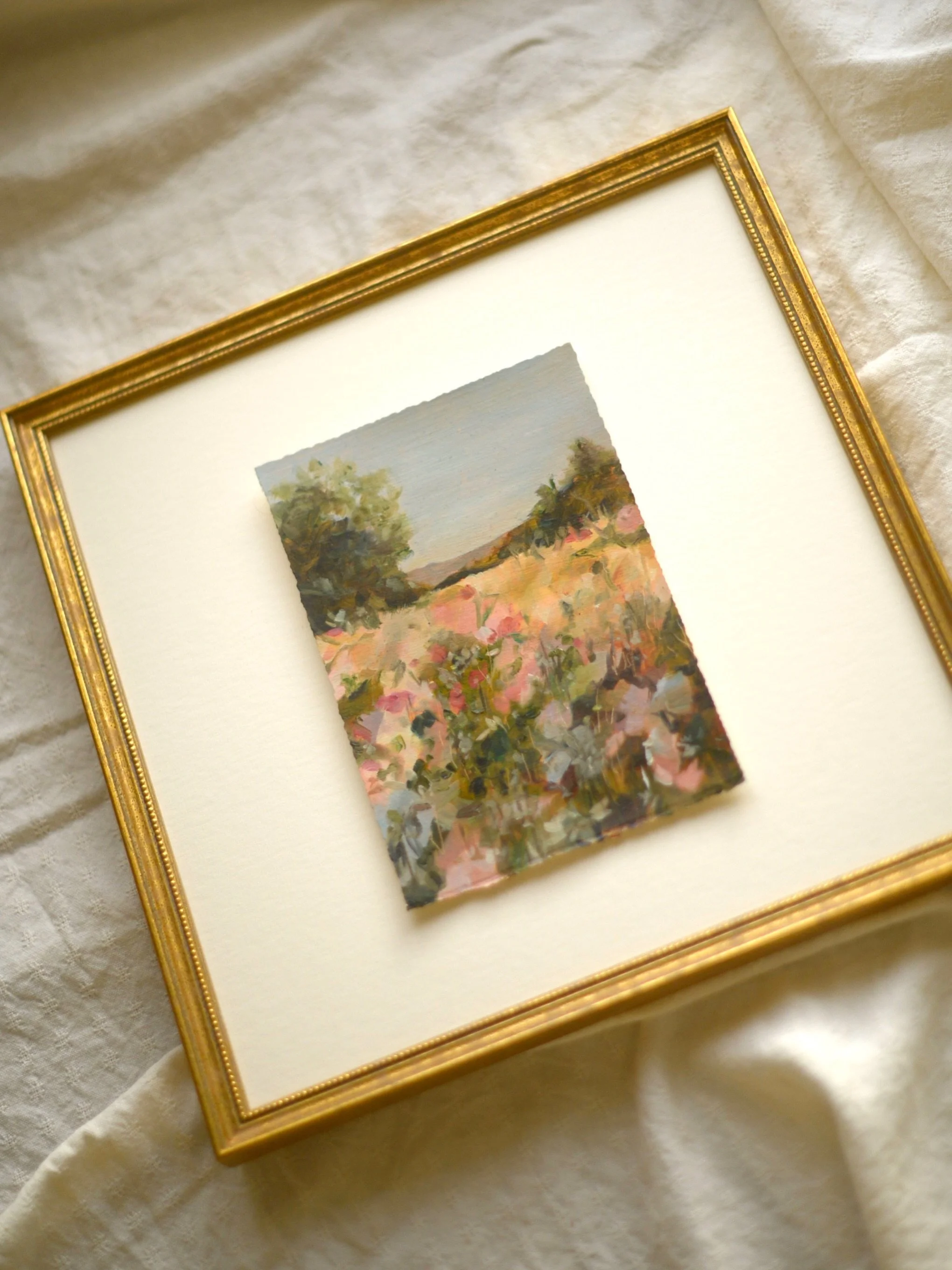 A small original oil landscape, painted on paper, with soft colour, loose brushwork and that last warm light you get across a field at the end of the day.

I found the gilt frame afterwards, and it completely changed the piece. It gave the painting a
