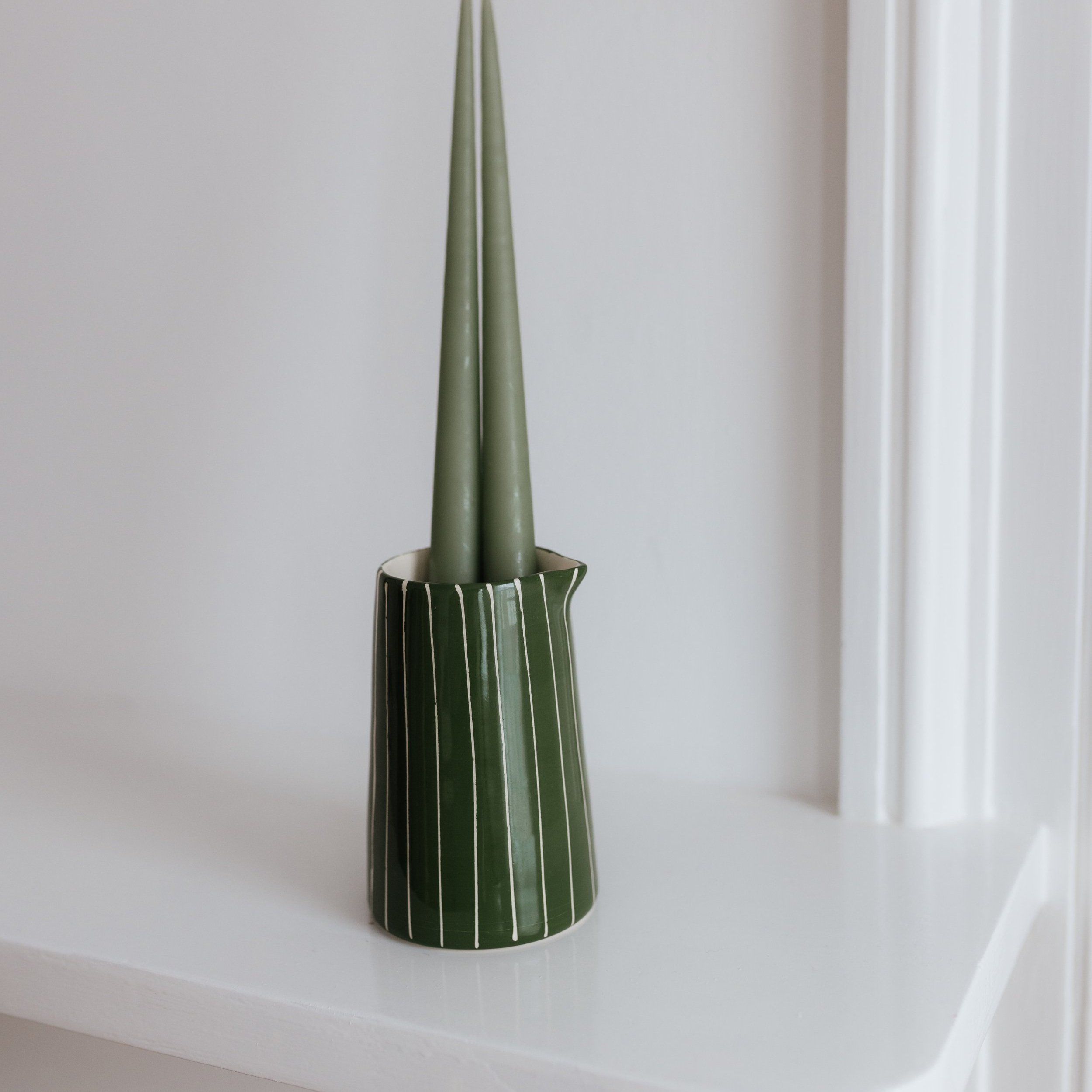 green creamer with green candle
