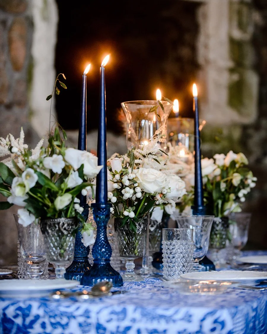 Bespoke Design Service. Floral table design with white flowers and dark blue tall candles
