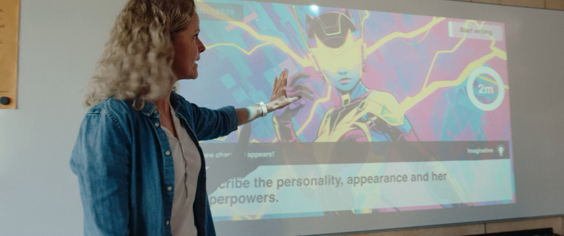 Teacher showing a WeWillWrite writing prompt in the classroom