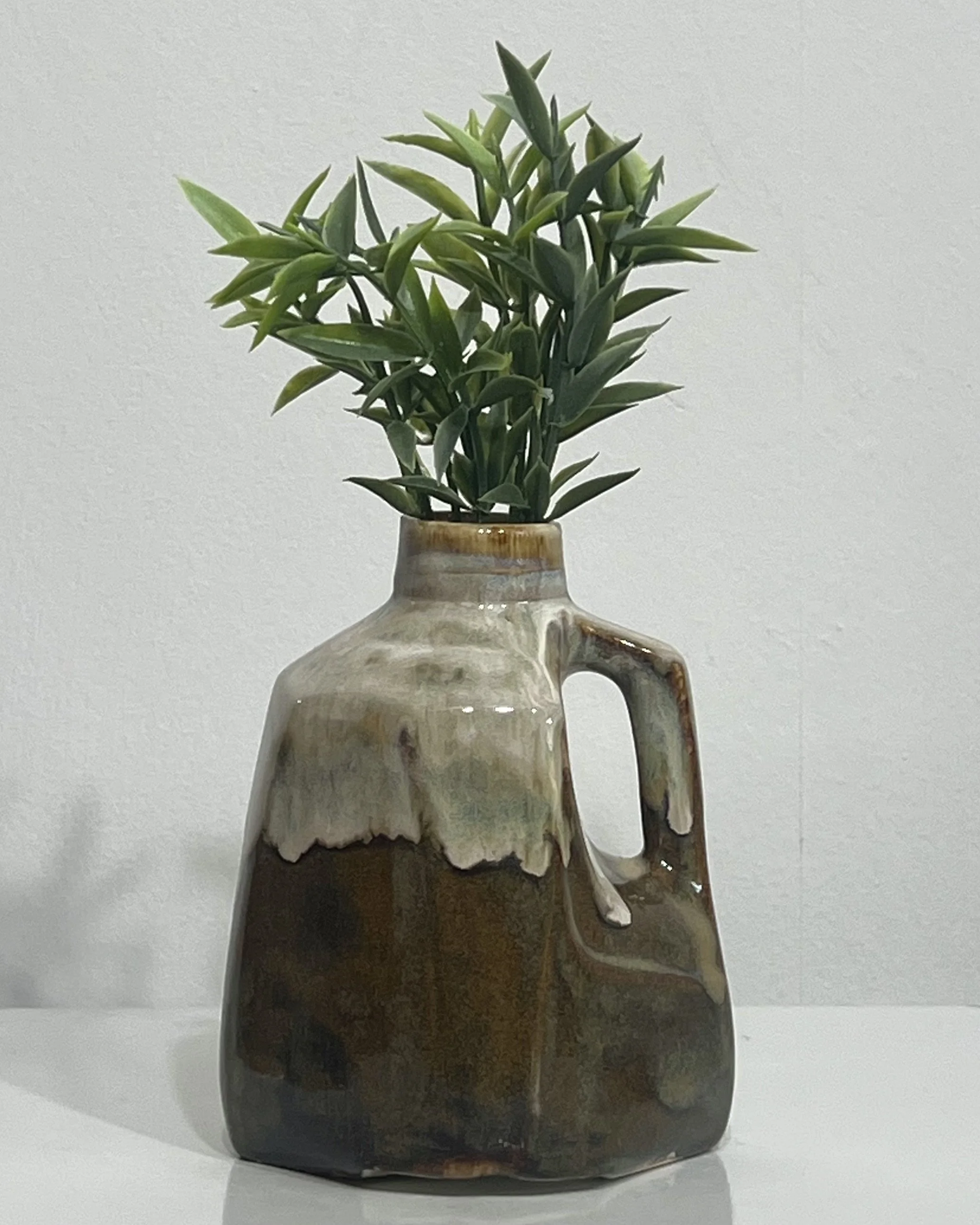 Handmade porcelain milk jug vase by Alissa Van Atta featuring layered Iron Lustre and Honey Flux glazes in deep brown, smoky olive, and honey tones.