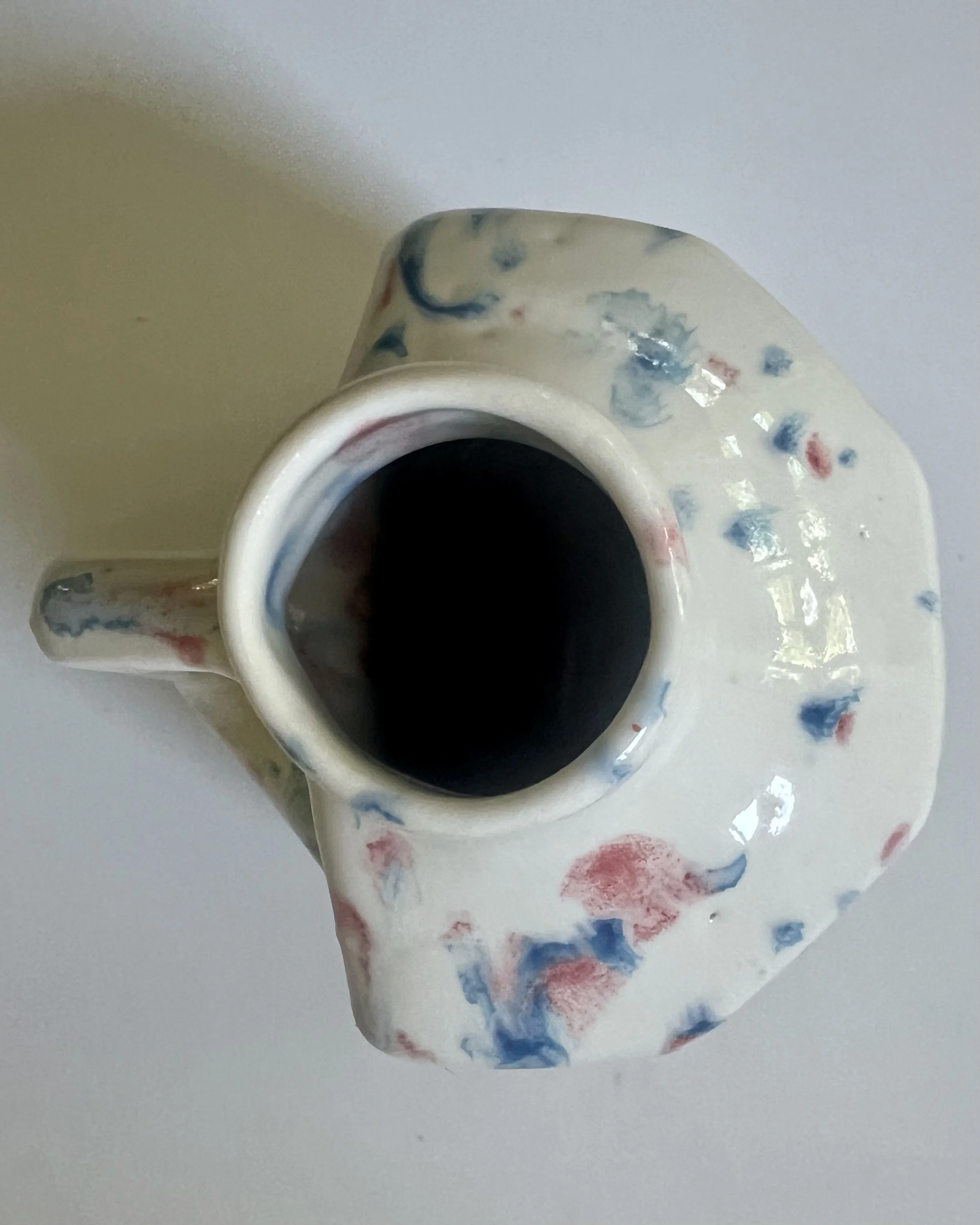 Top view of Kaboom porcelain milk jug vase showing opening and interior glaze.