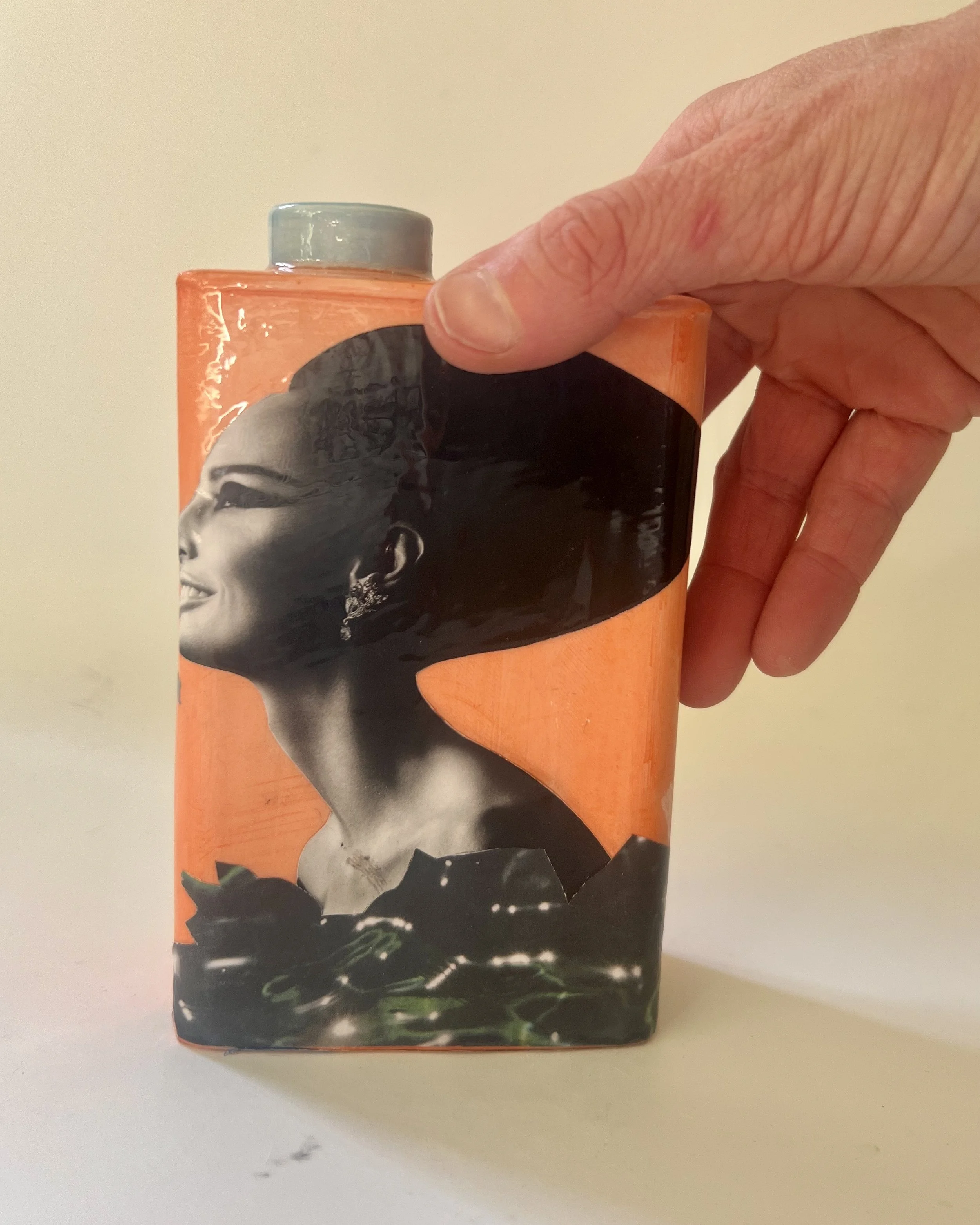 Time Bomb porcelain Art Carton shown in hand for scale, handmade by Asheville artist Alissa Van Atta.