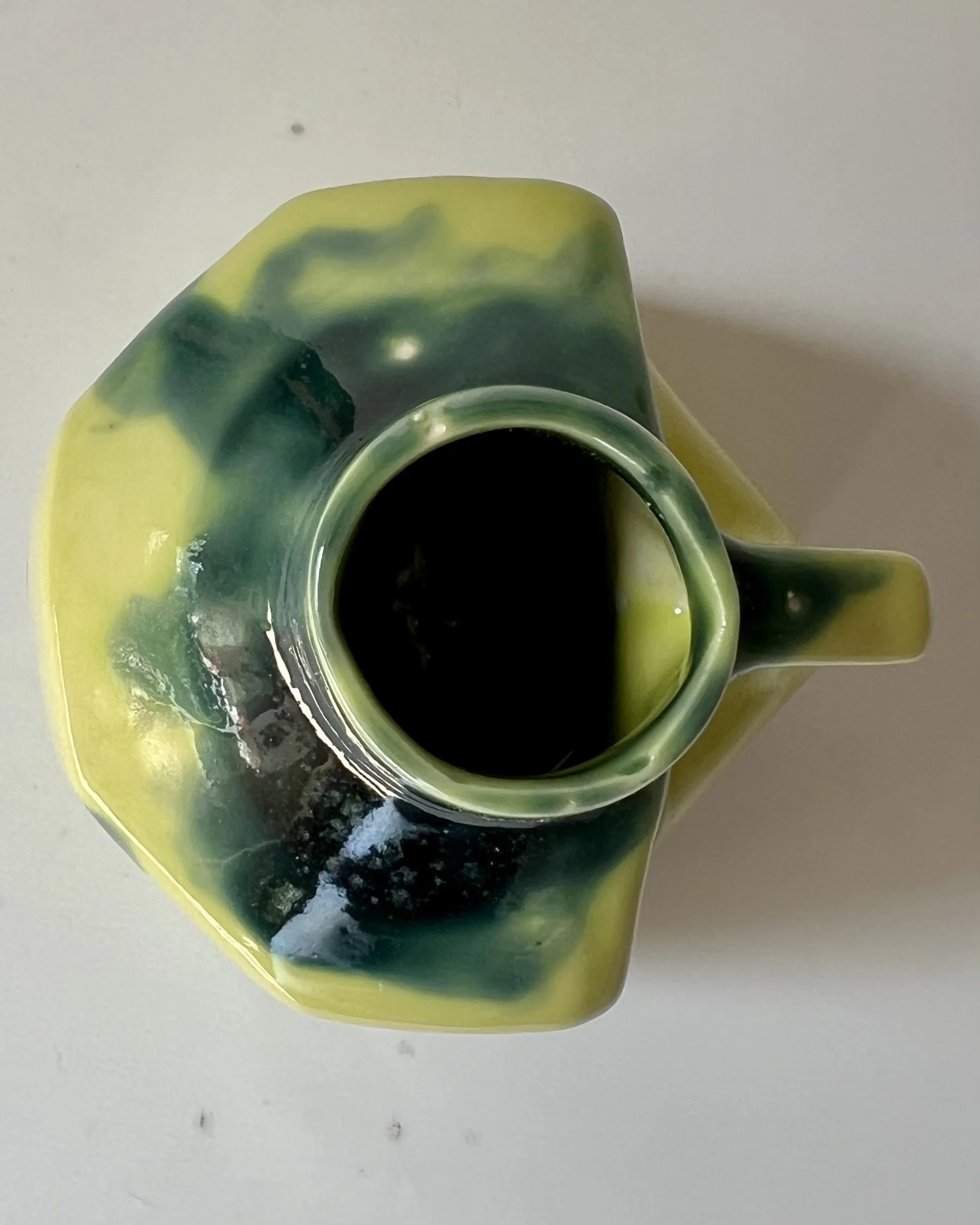 Top view of a handmade porcelain milk jug showing the opening and interior.
