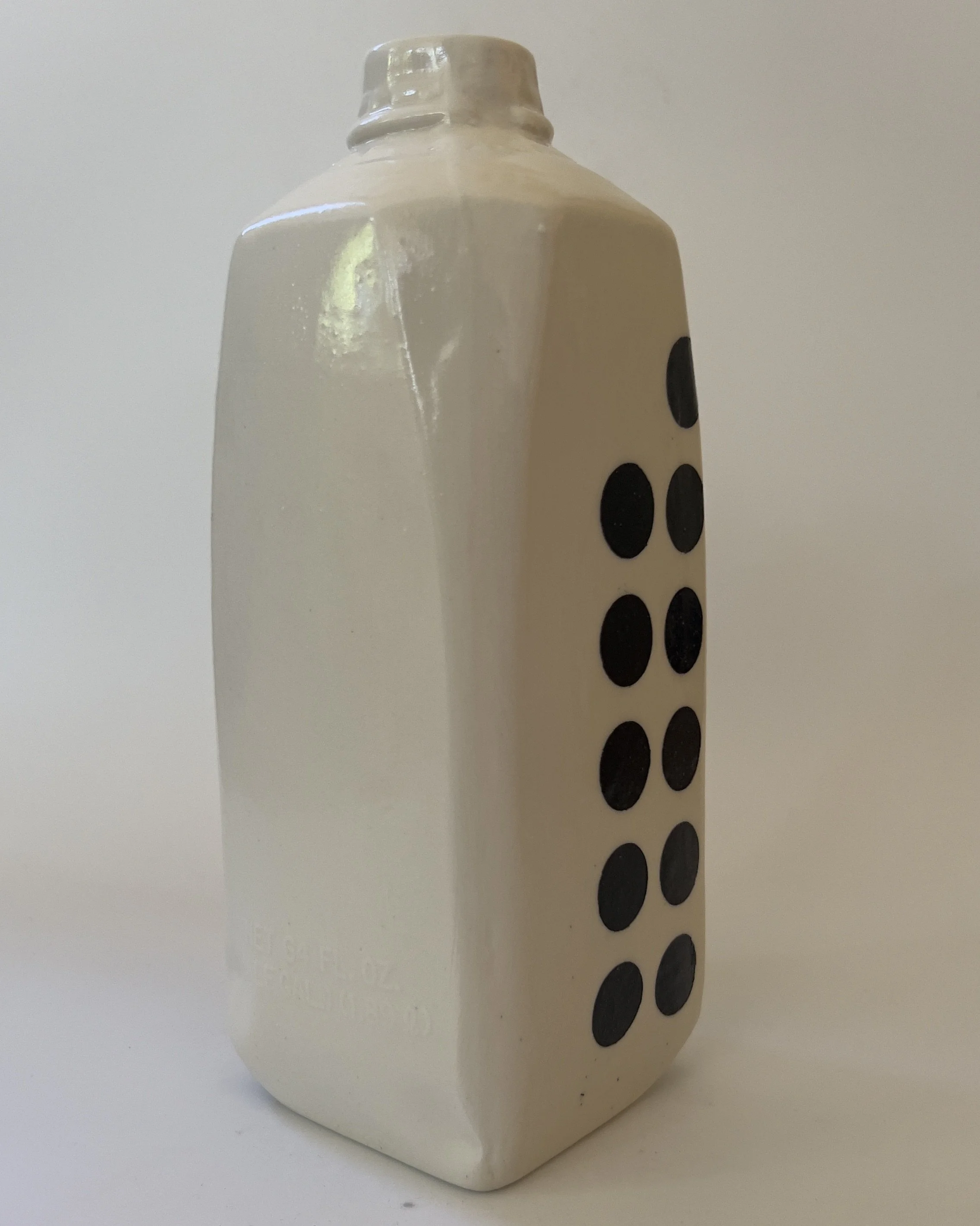 Back view of handmade white ceramic vase with soft geometric form