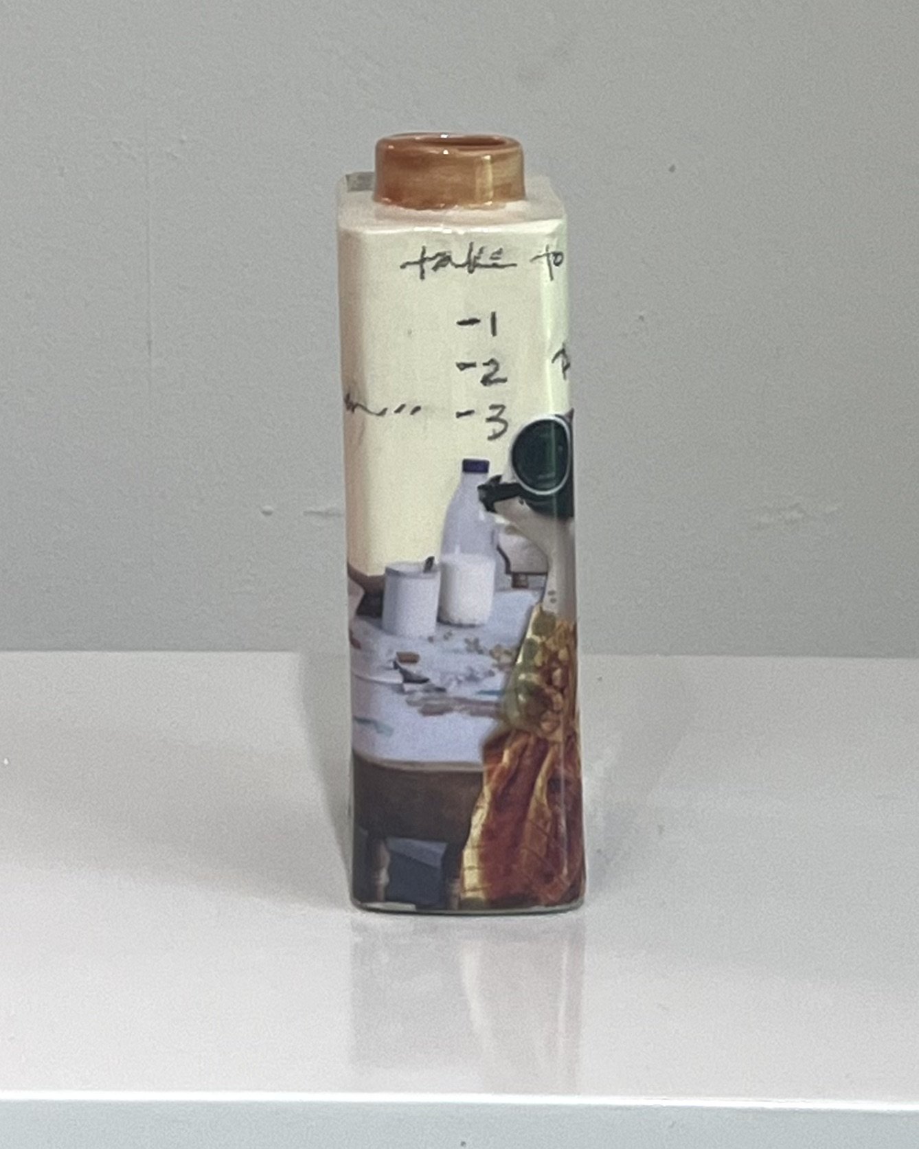 Left side view of Some Assembly Required porcelain Art Carton showing layered collage imagery and contemporary mixed media details.