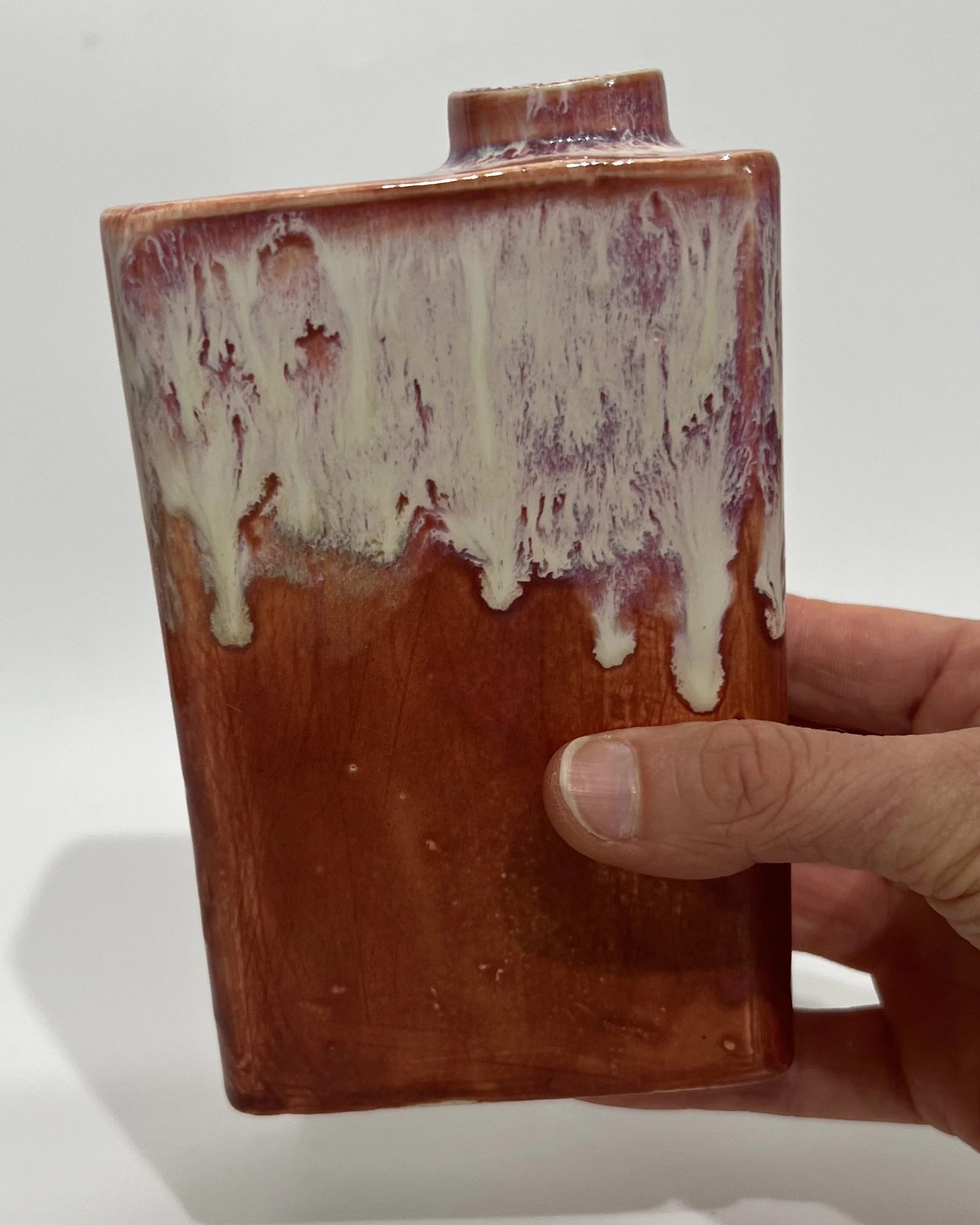 Ceramic carton held in hand to show the scale and sculptural proportions of the vessel