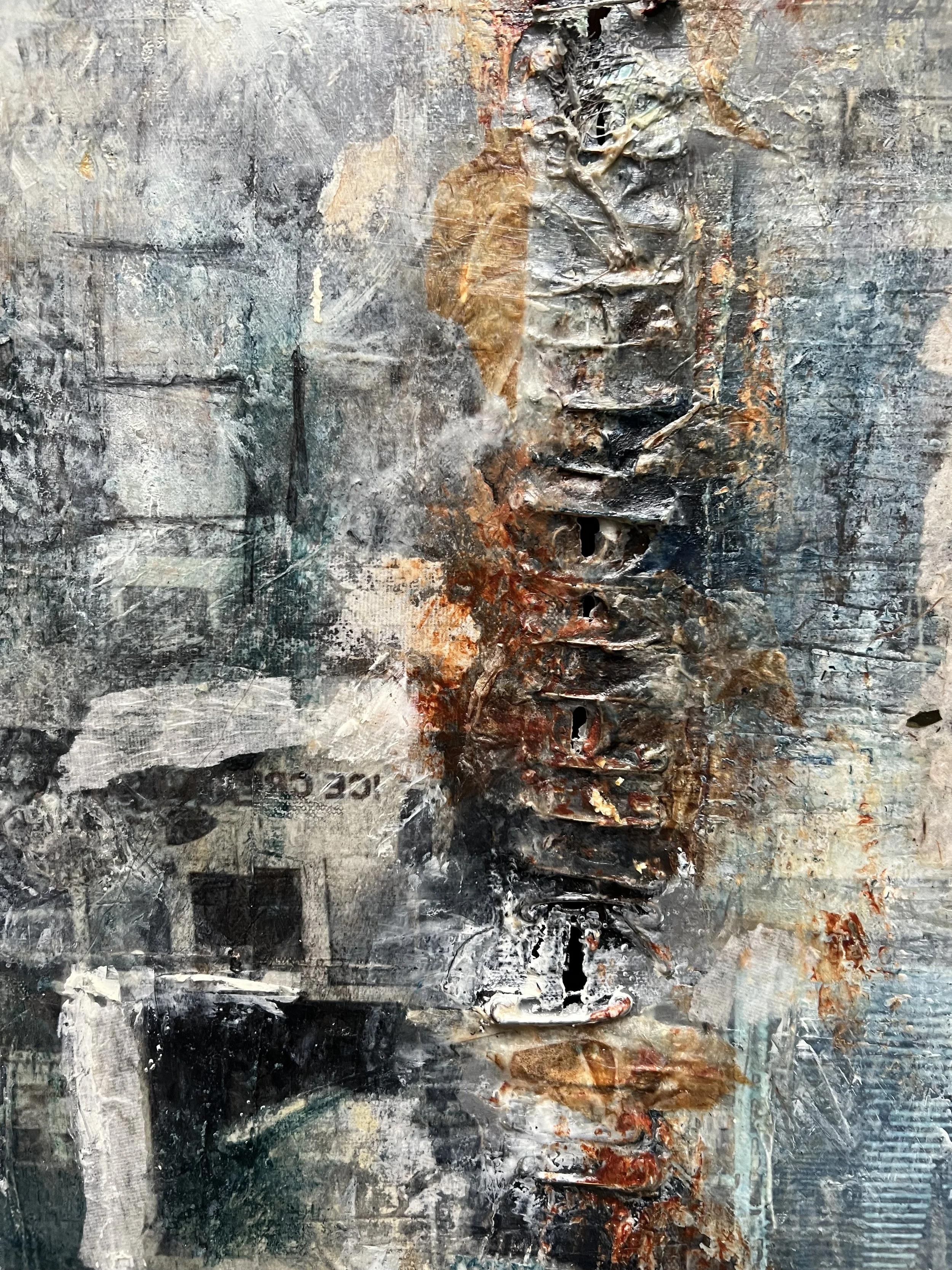 Close-up of Indigo by Alissa Van Atta showing layered cold wax, transferred New York City architectural imagery, distressed surfaces, and blue and rust textures.