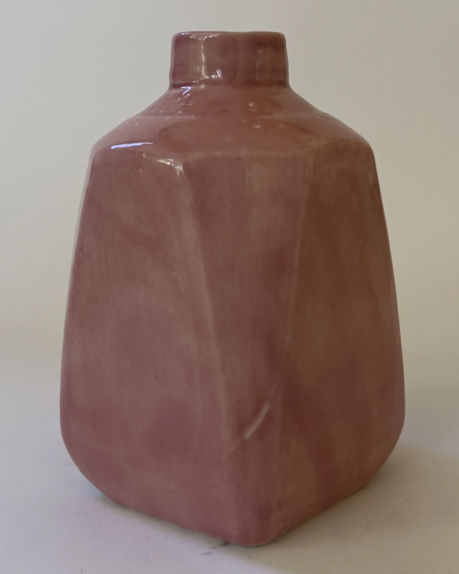 Back view of handbuilt ceramic jug sculpture in glossy pink glaze