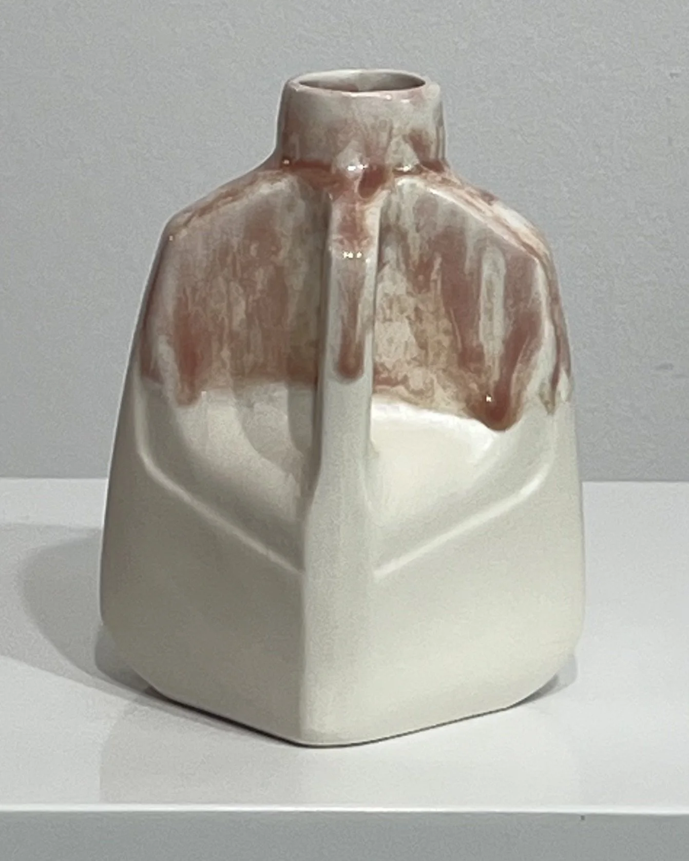 Angled view of porcelain jug showing flowing Weeping Plum and Light Flux glaze