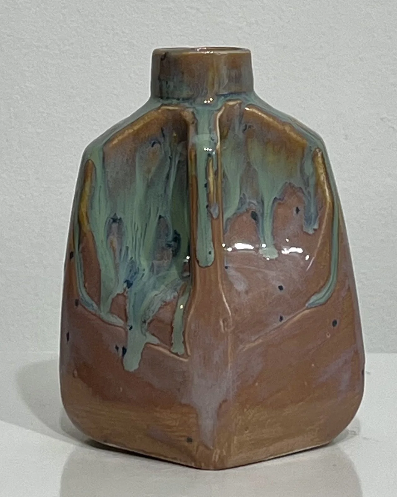 Angled view of ceramic milk jug showing Purple Aster and Micro Jade glazes