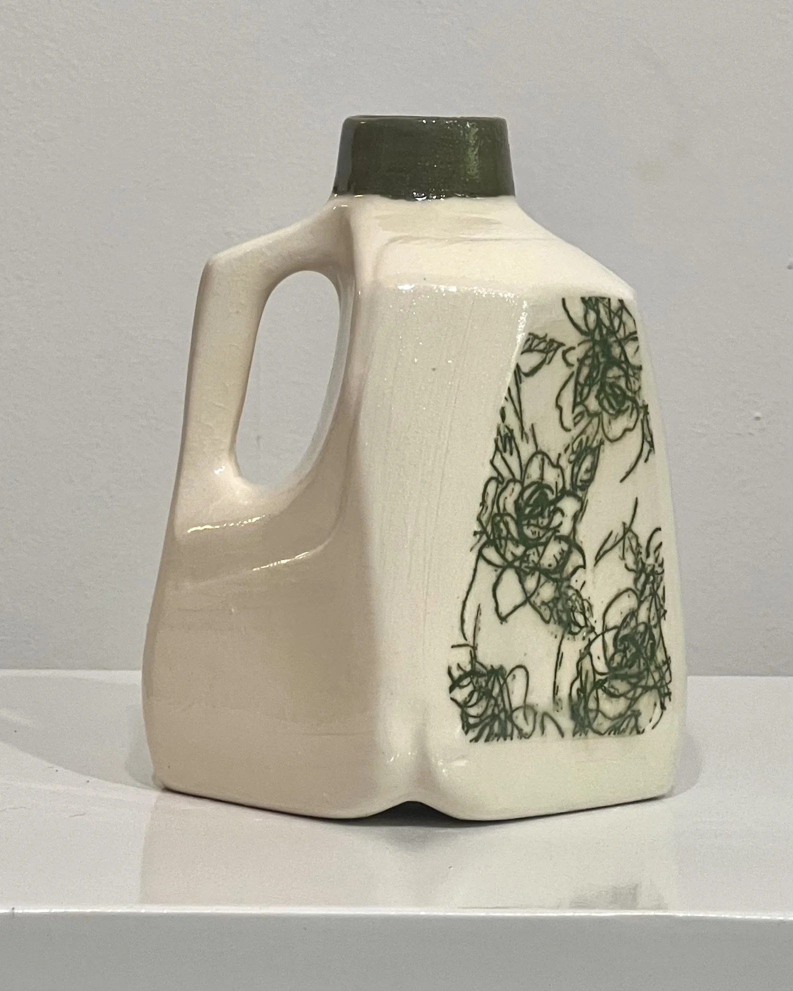 Side view of Verdant Sketch contemporary porcelain milk jug vase with green botanical transfer and clear glossy glaze.