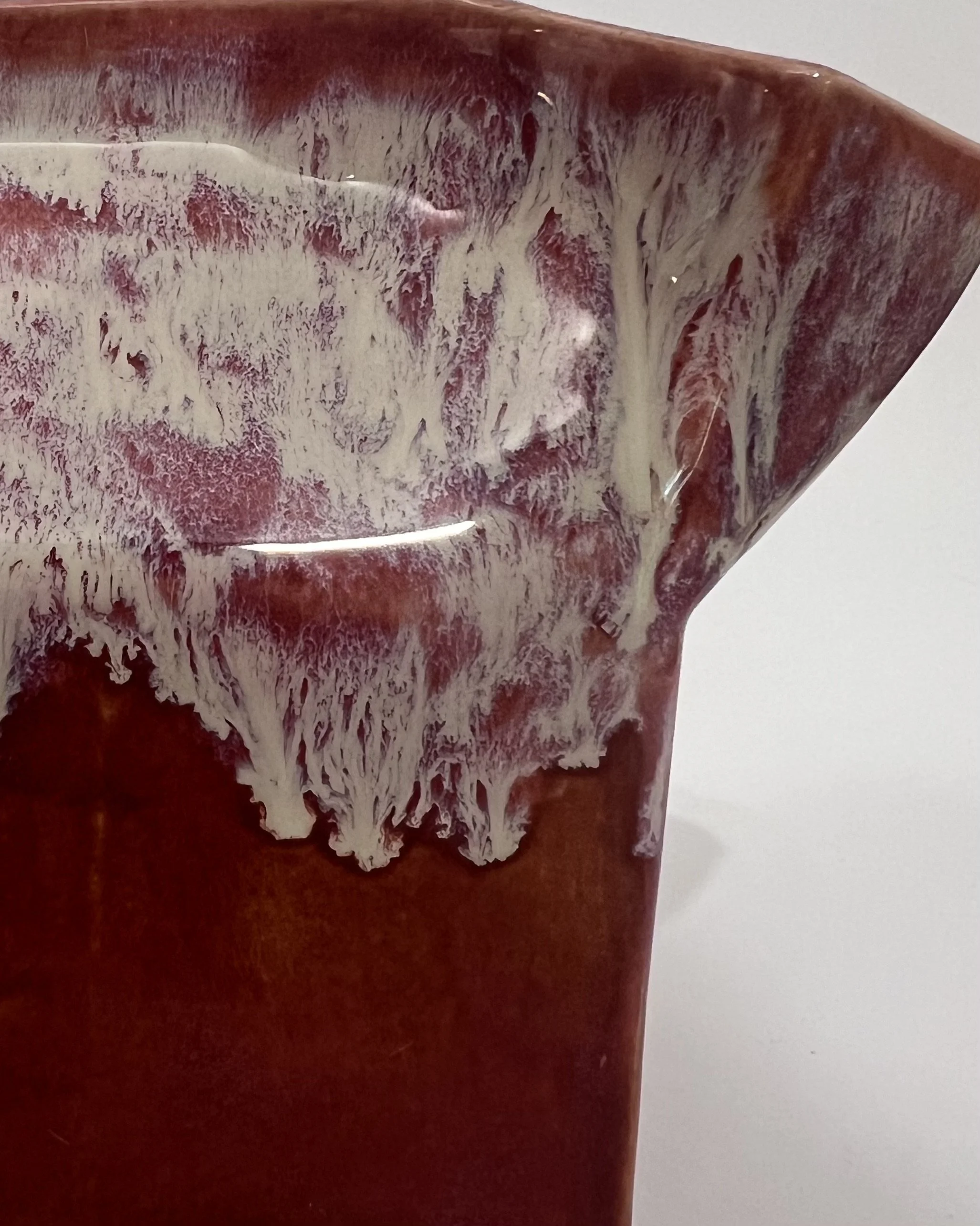 Close-up of Chun Plum and Light Flux glazes showing cream, blush, plum, and rust red surface variations.