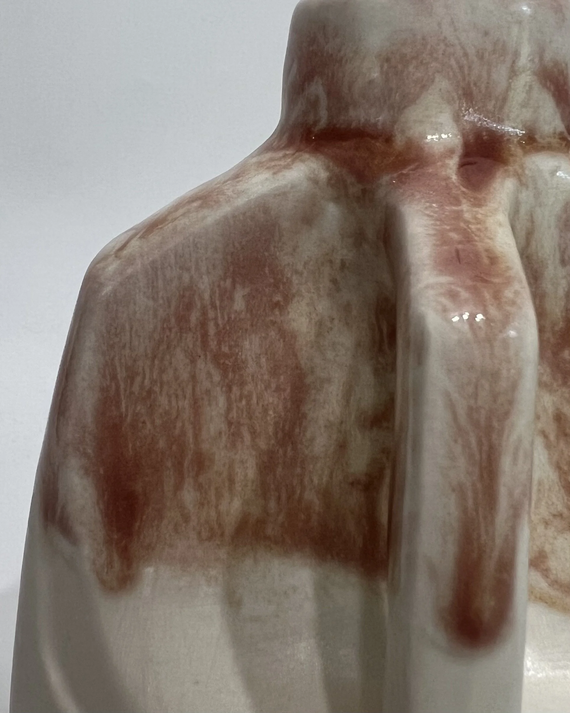 Close-up detail of Weeping Plum glaze flowing over white porcelain