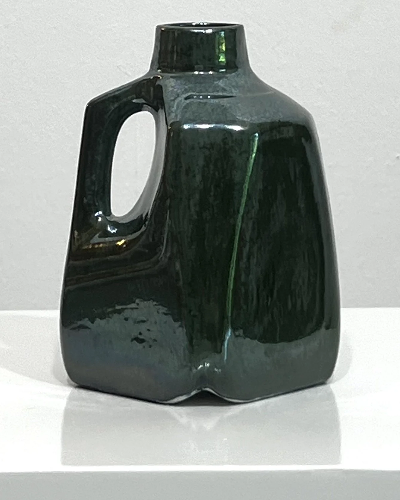 Side view of sculptural porcelain milk jug 26.48 showing the angular body and handle.