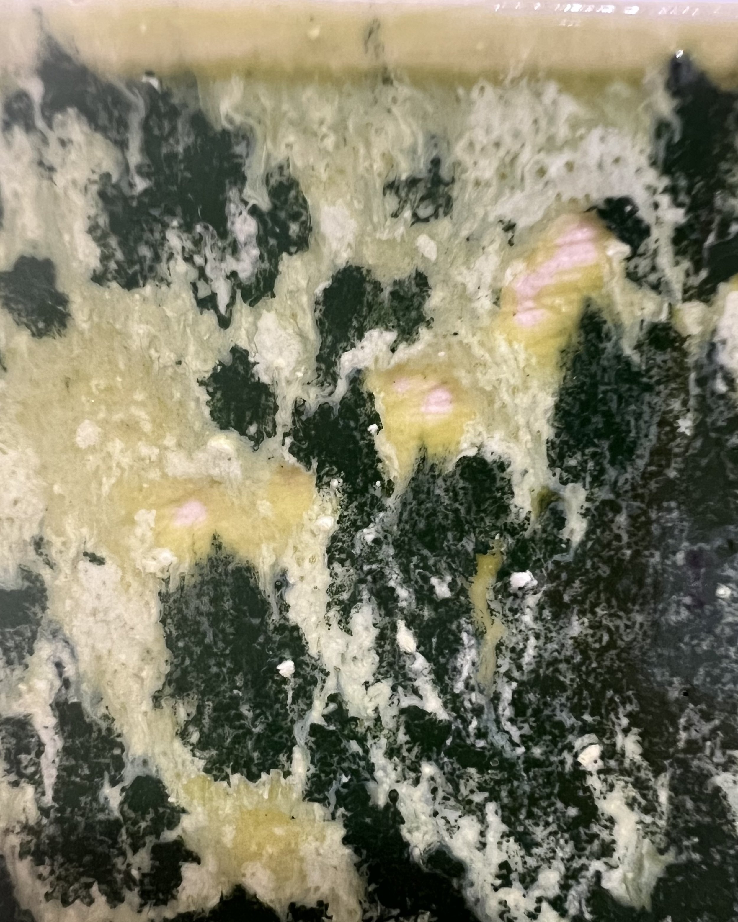 Close-up of Lime Shower ceramic glaze showing chartreuse, dark forest-green markings, and organic surface patterns