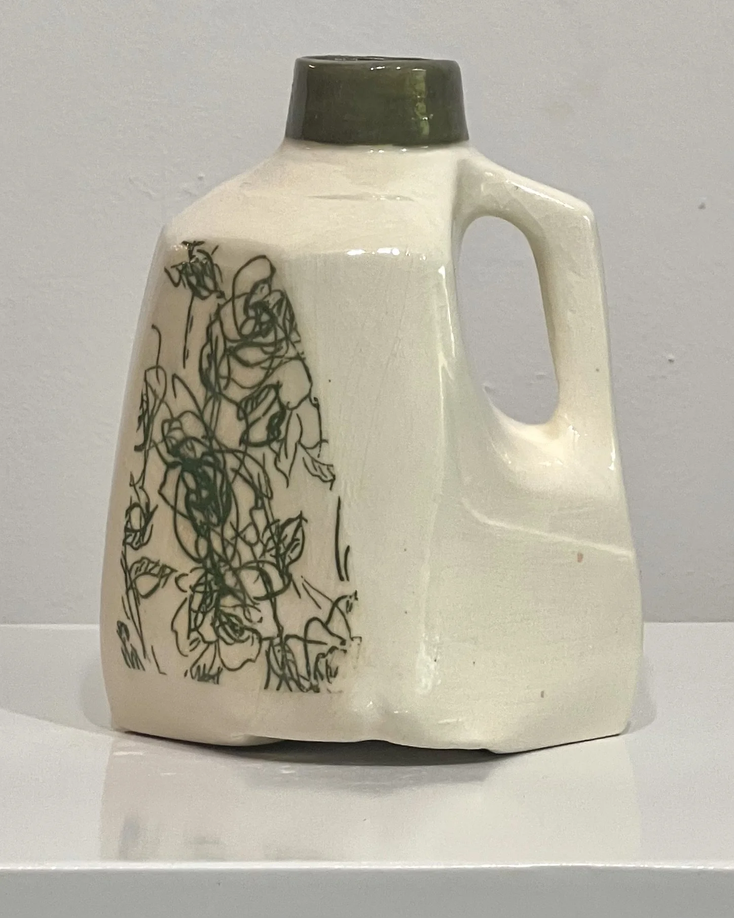 Front view of Verdant Sketch porcelain milk jug vase featuring a green botanical transfer beneath a glossy clear glaze.