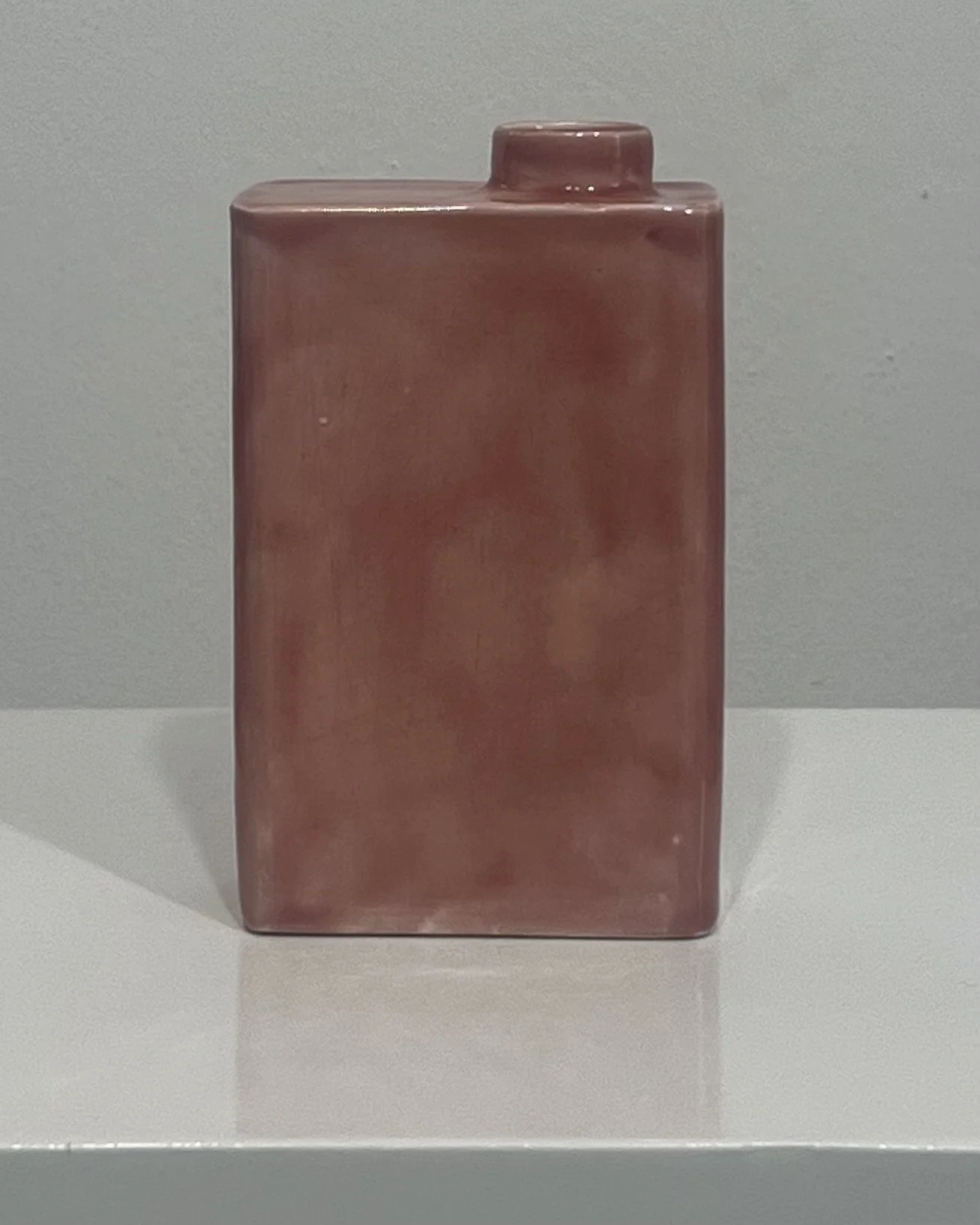 Back view of handmade porcelain carton vase with soft blush pink Weeping Plum glaze.