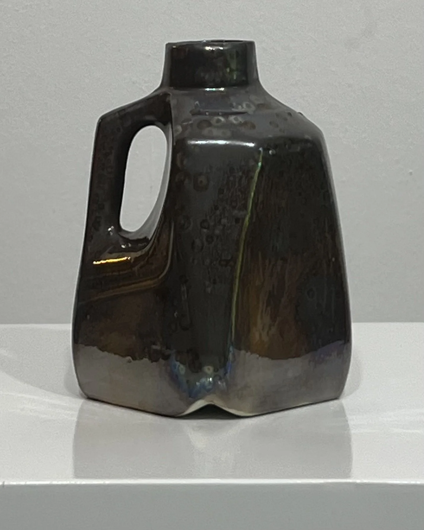 Side view of handmade ceramic milk jug in Vintage Gold glaze
