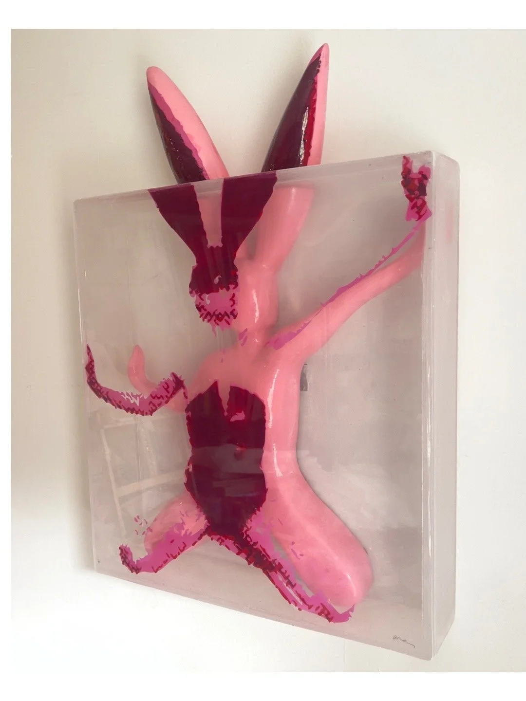 Detail of “Wait for Me, I Think I’m Worth It” by Alissa Van Atta, resin sculpture of a pink bunny figure pressed against a translucent surface