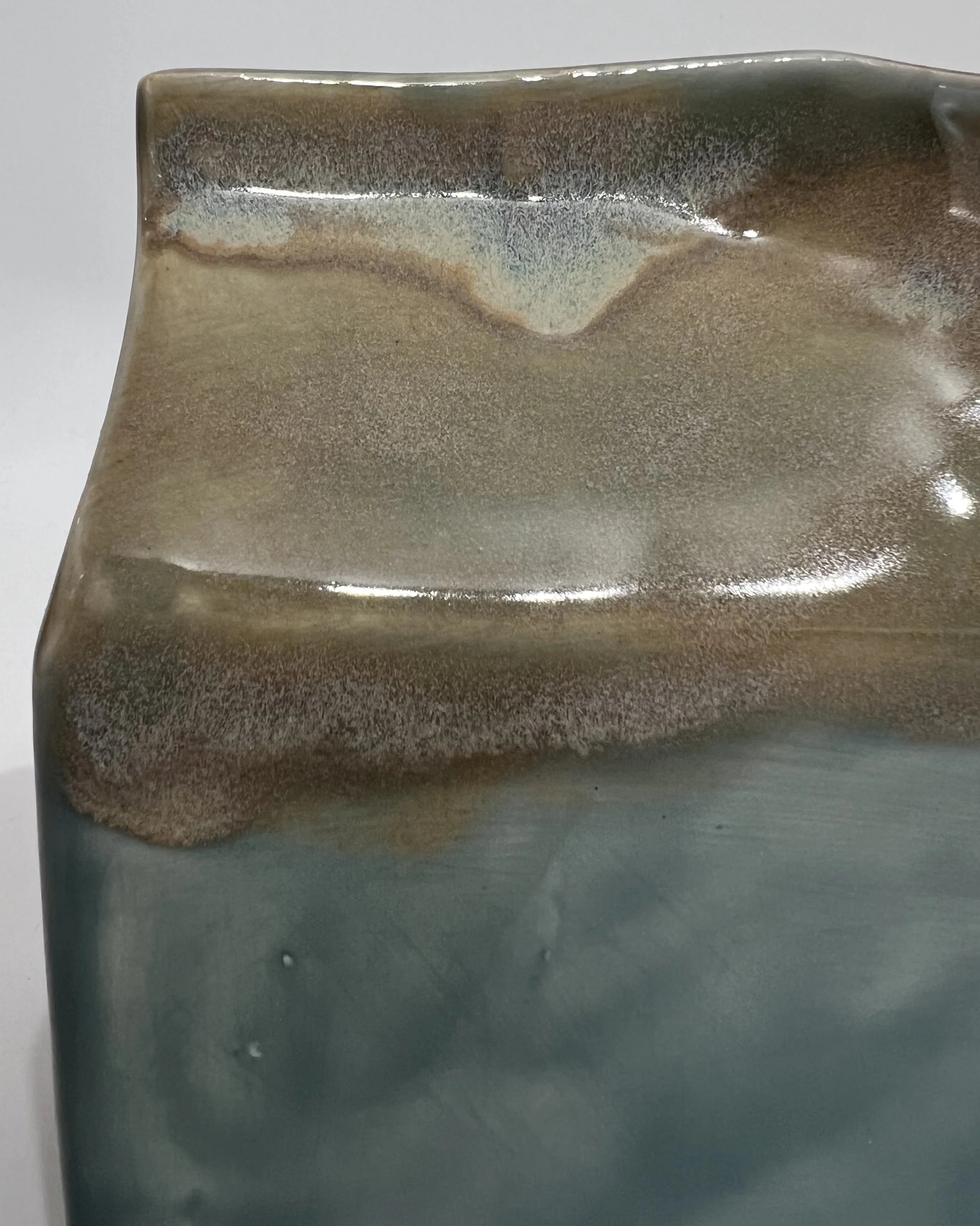 Close-up of Fog and Mystic Tide glazes showing the layered surface, color variation, and glossy finish.