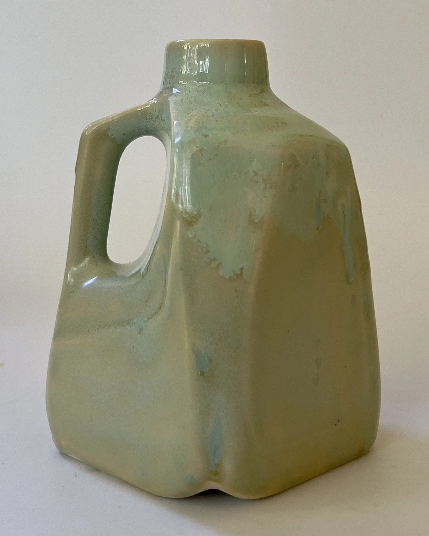 Geometric handmade ceramic jug with soft green and sand-toned glaze
