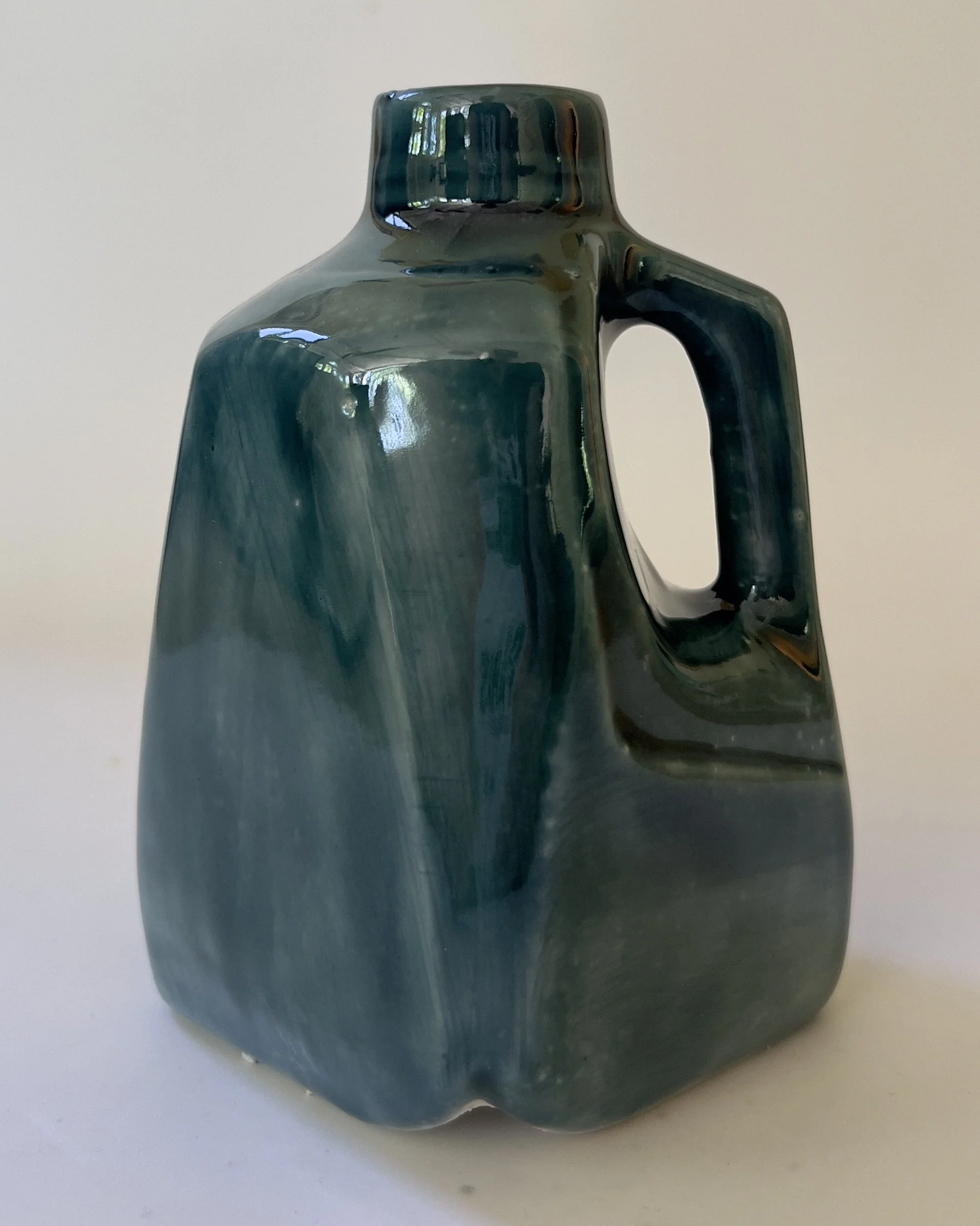 Handmade ceramic jug vase with glossy rainforest glaze in deep teal and blue-black tones