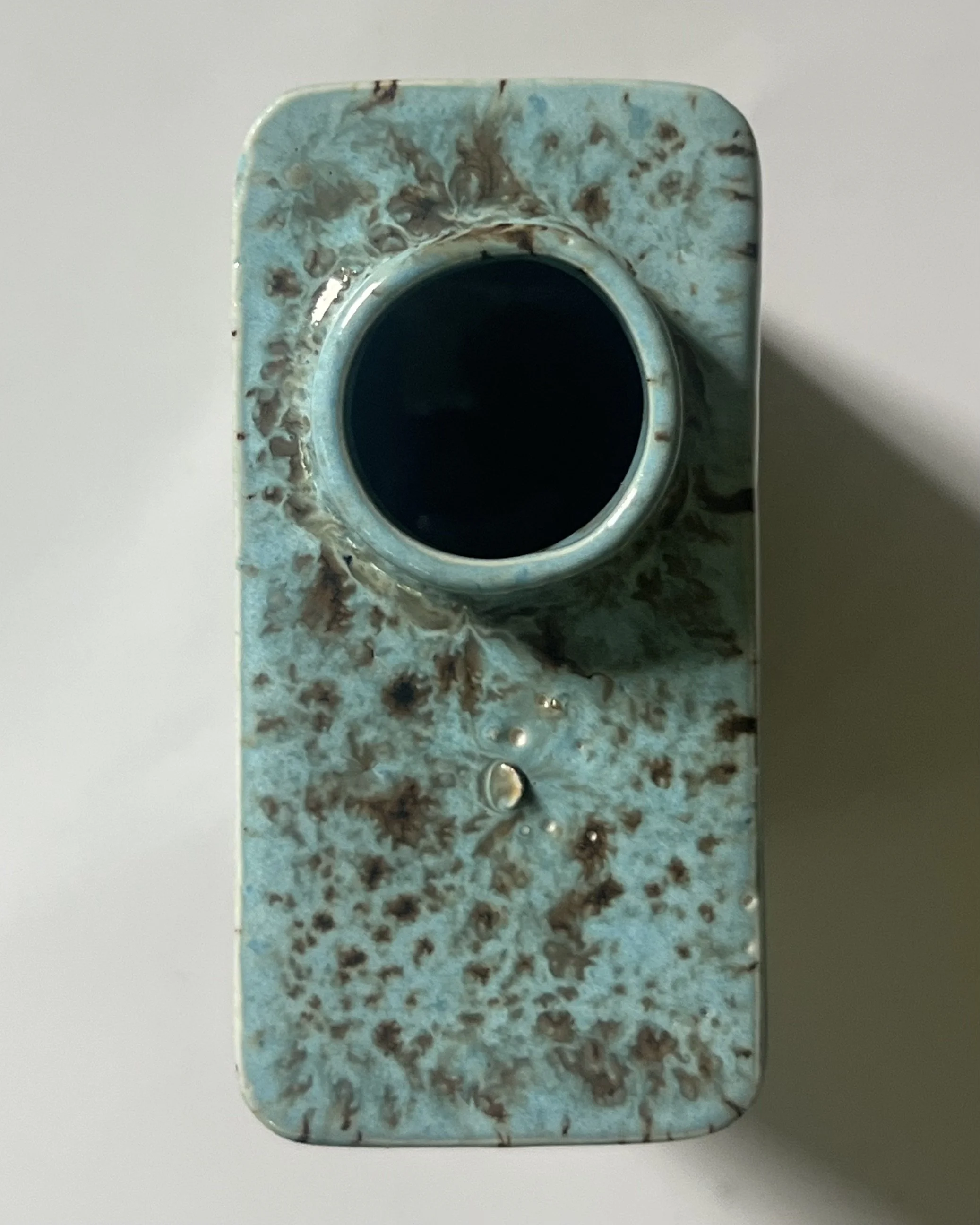 Top view of porcelain carton vase with circular opening and crystalline Cenote glaze effects.