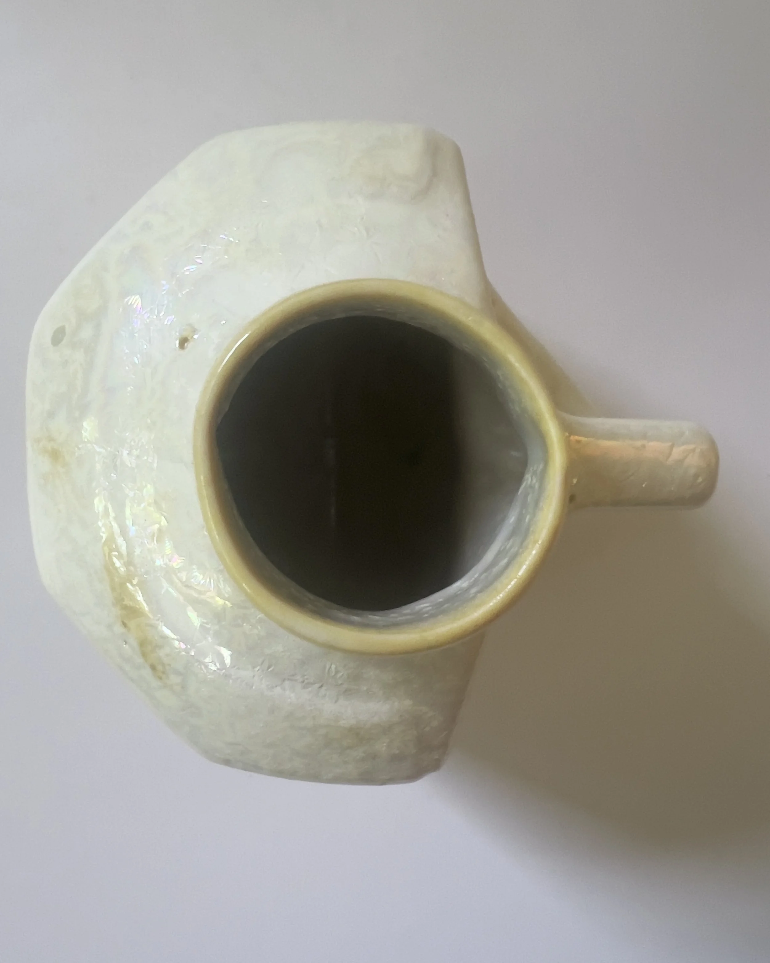 Top view of handmade ceramic milk jug vase showing circular opening and iridescent glaze detail