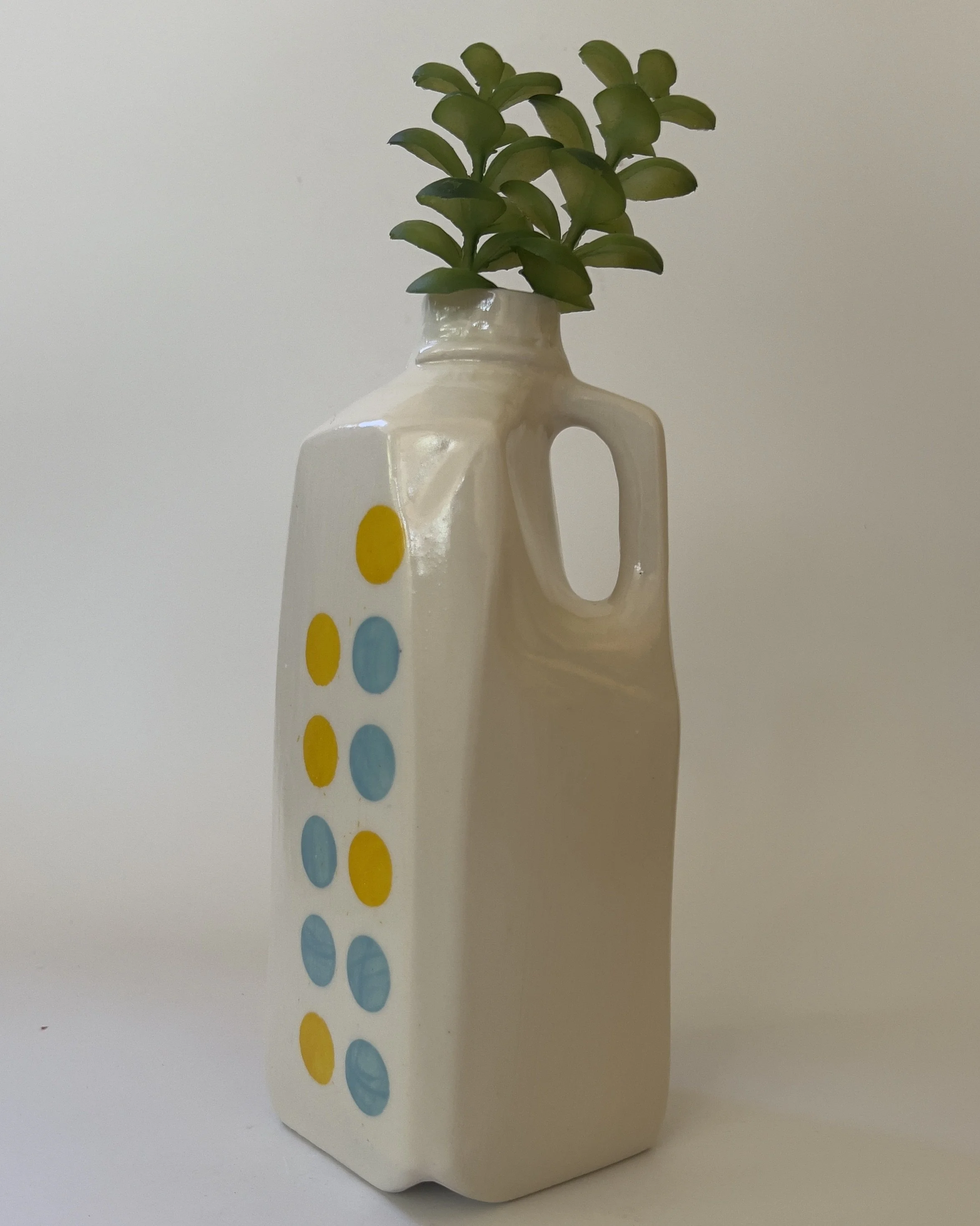 Tall ceramic jug vase with dandelion yellow and jade blue dots on pearlescent white glaze