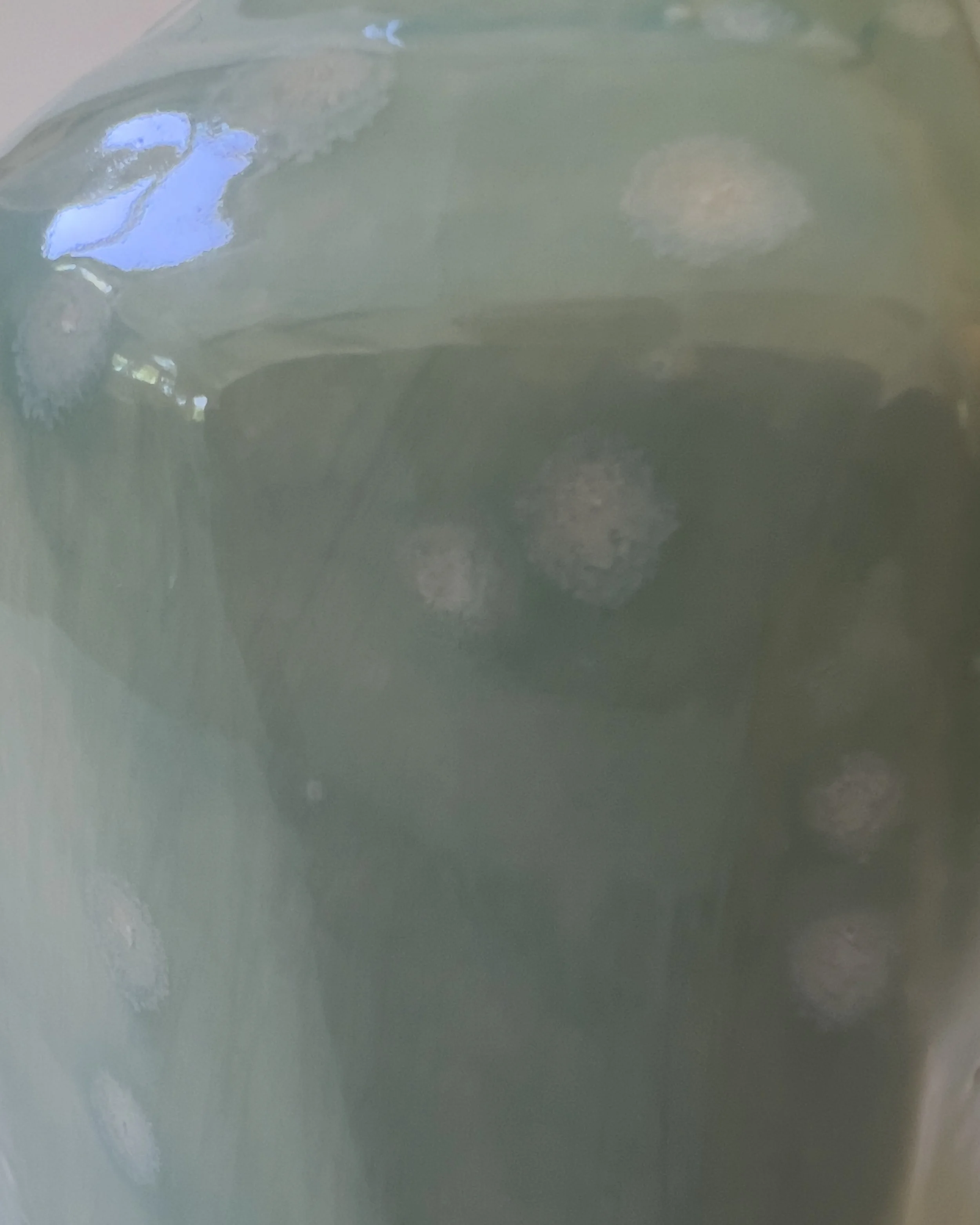 Detail of celadon bloom glaze texture on handmade ceramic milk jug