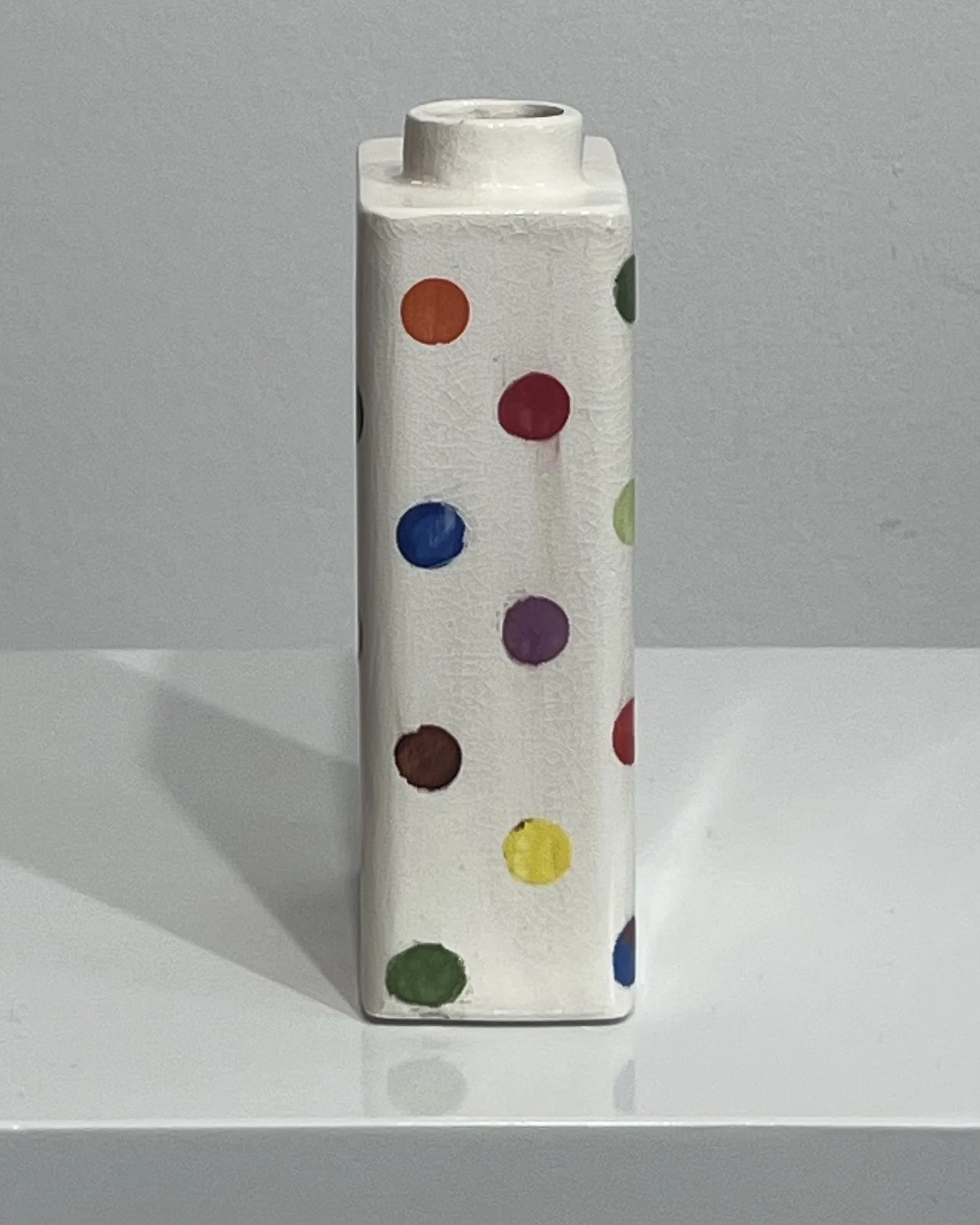 Side view of multicolor polka dot porcelain carton vase