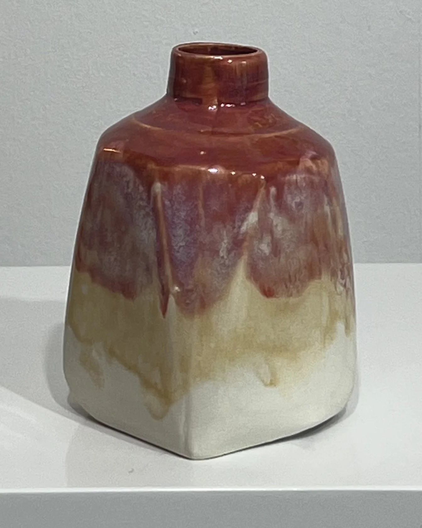 Alternate side of handmade porcelain milk jug featuring layered Chun Plum and Honey Flux glazes