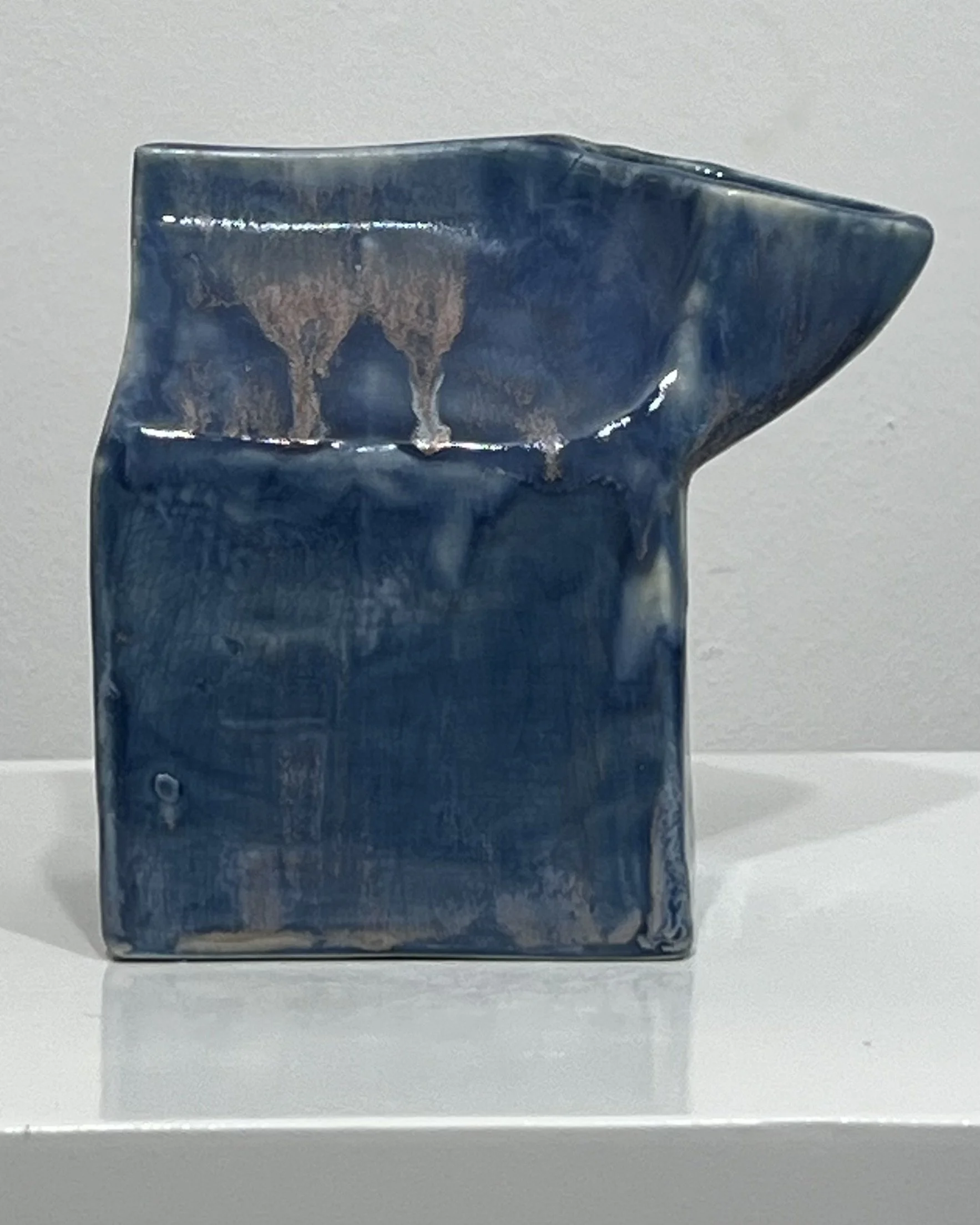 Side view of Milk Carton 26.2 Blue Splatter showing layered blue glazes with soft drips and atmospheric glaze movement.